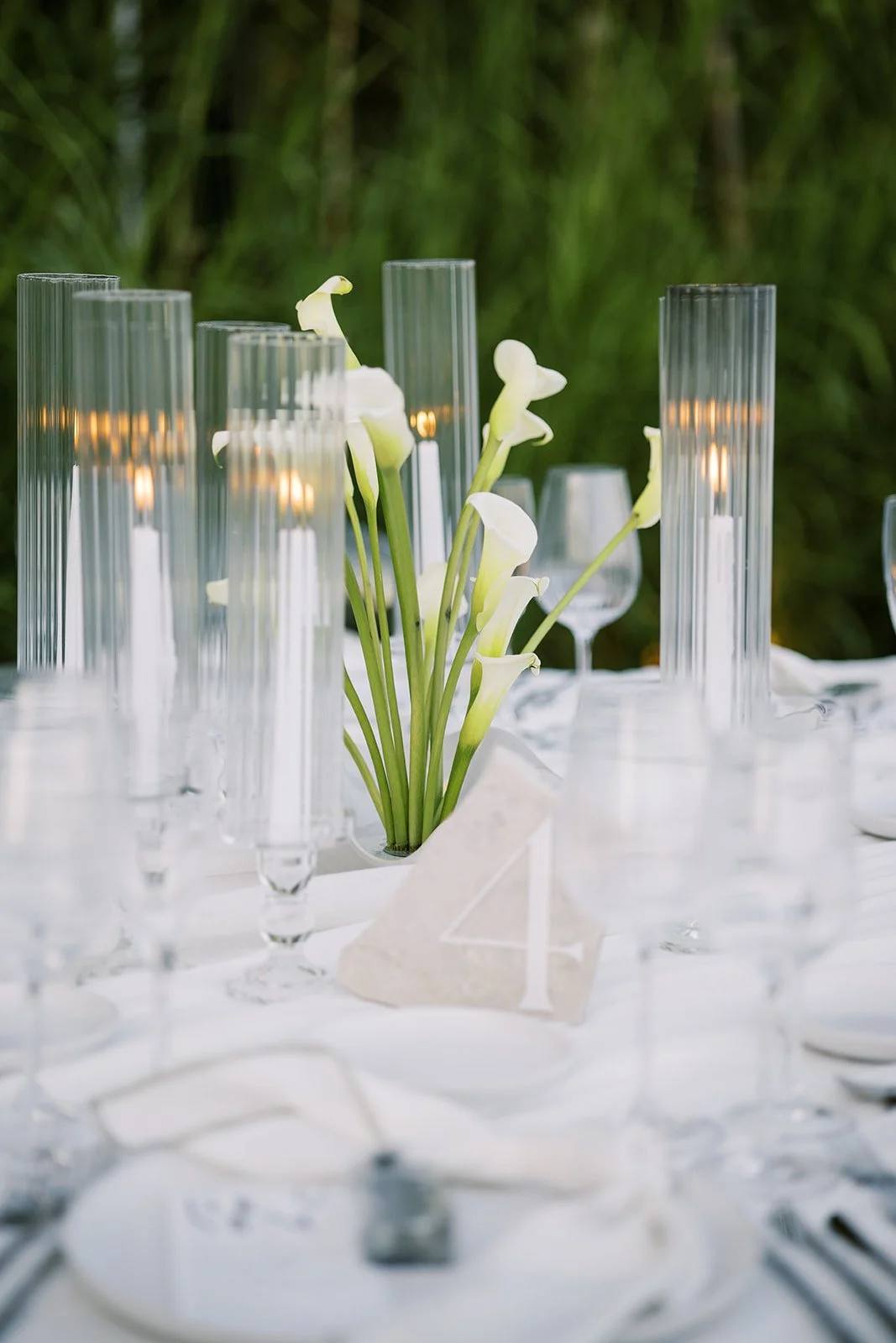 stone table number and white cala lily decor with white candles 