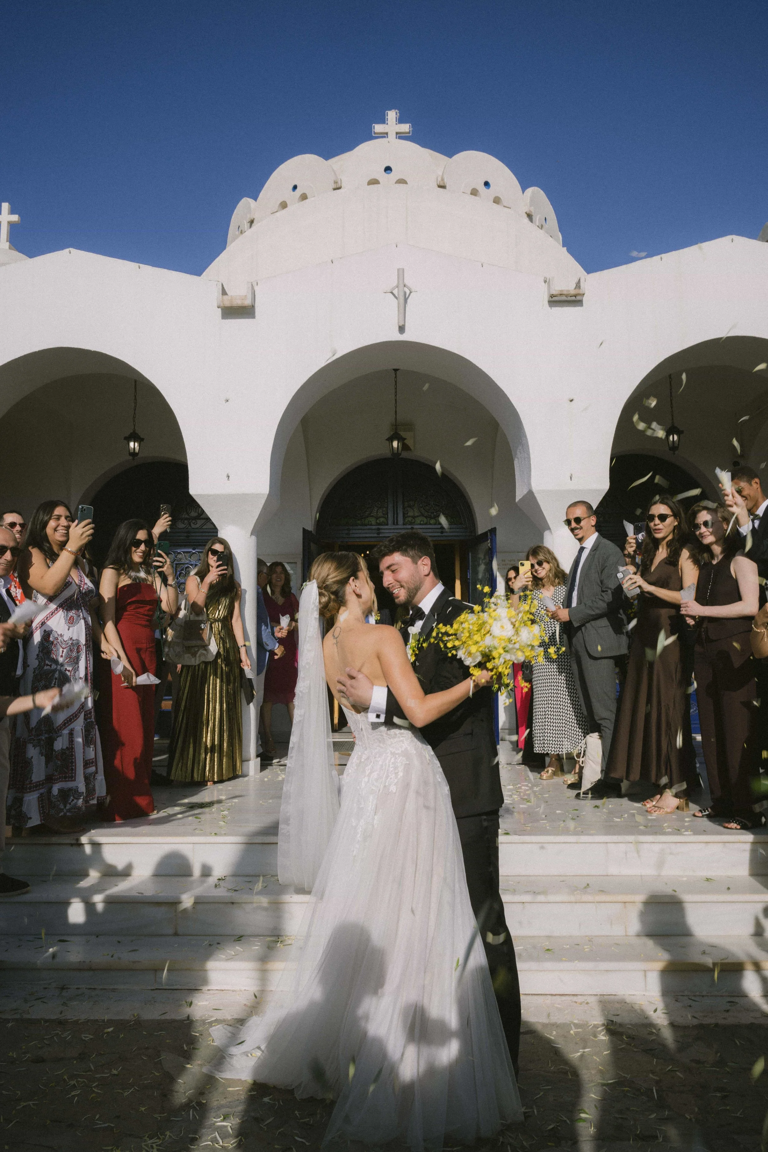 couple exit in from of church