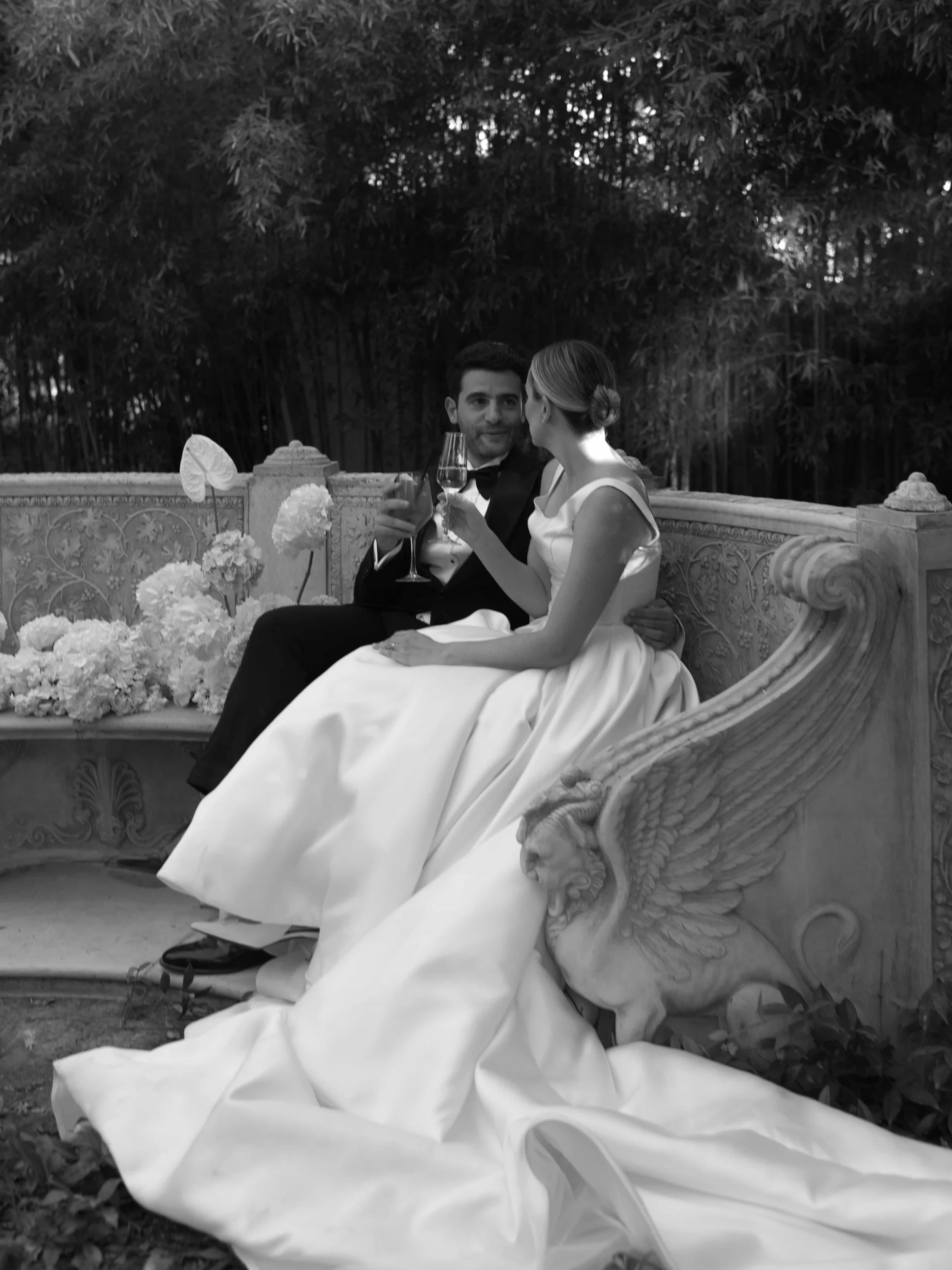 black and white picture couple on an italian bench with white hydrangeas 