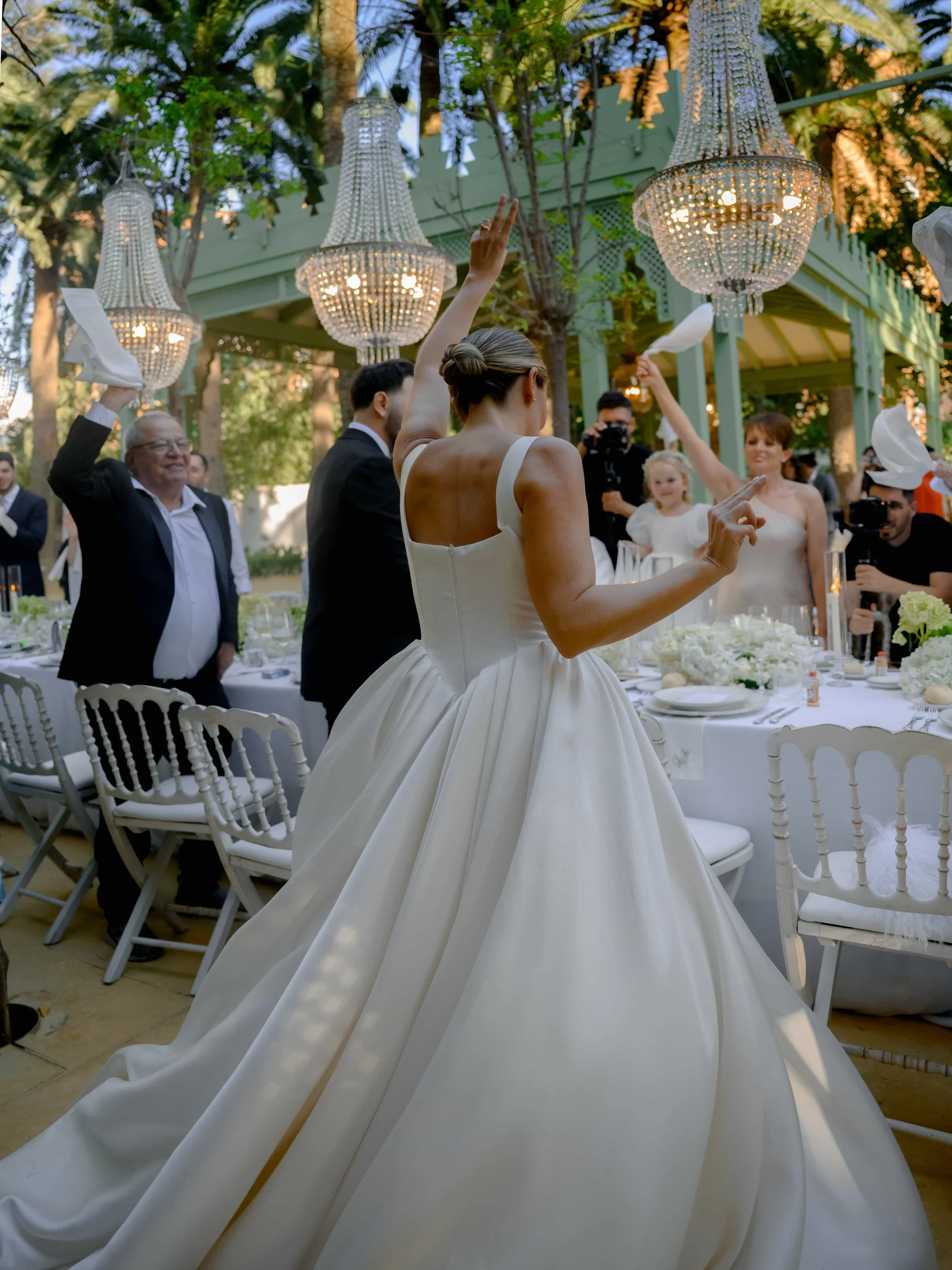 guests waving napkins during couple entrance 