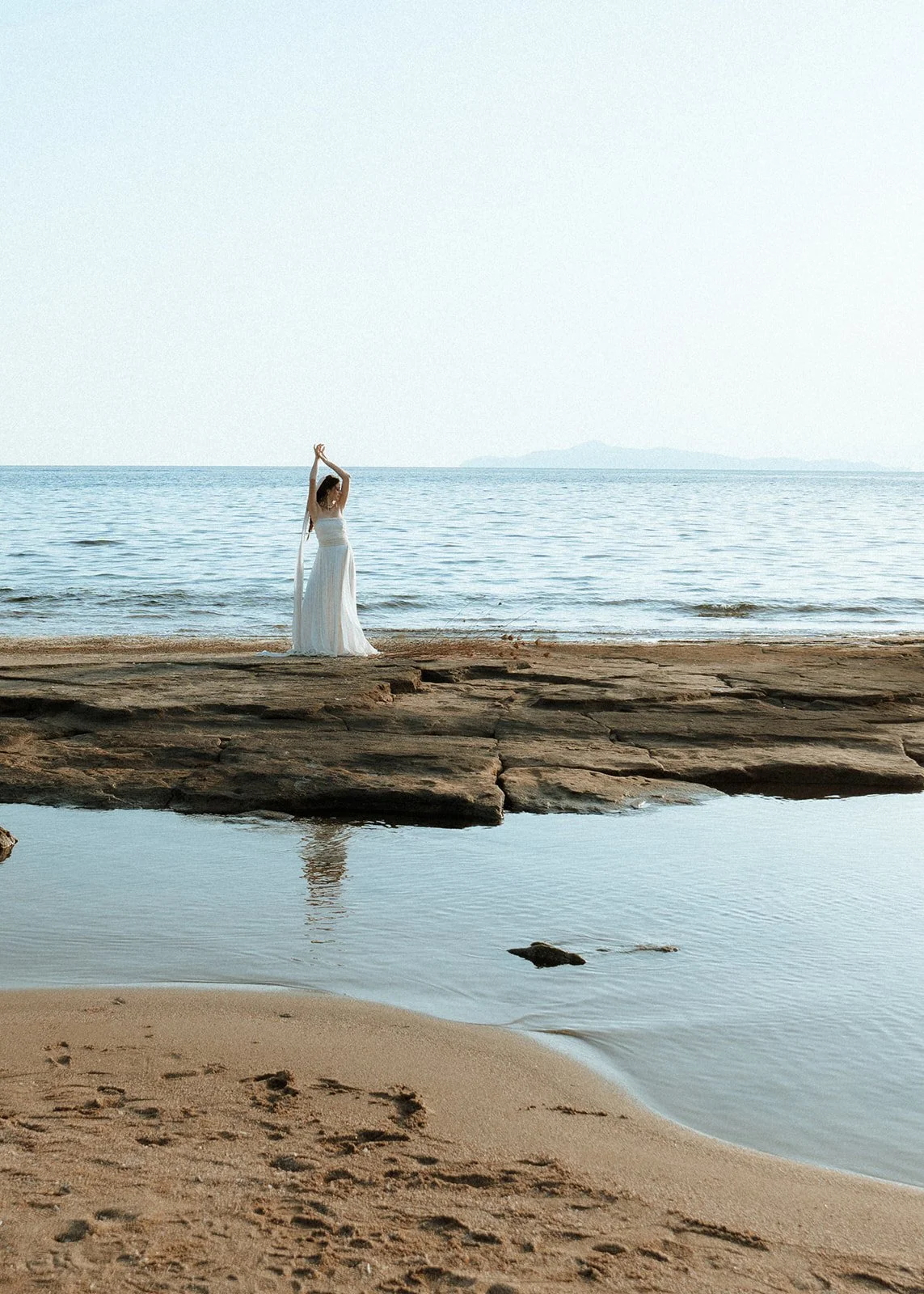 bride posing in the middle of the sea