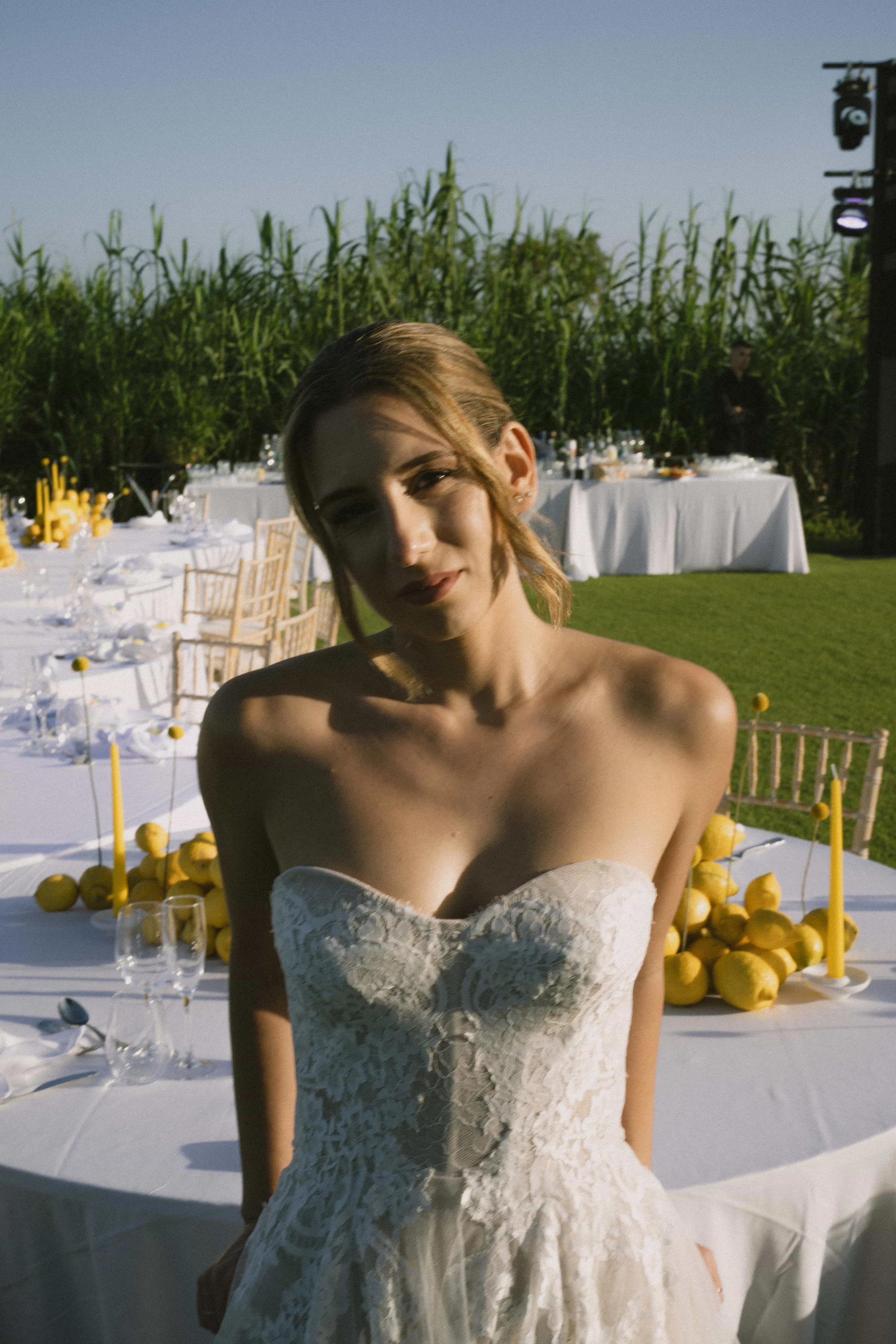 bride picture in front of lemon wedding setup