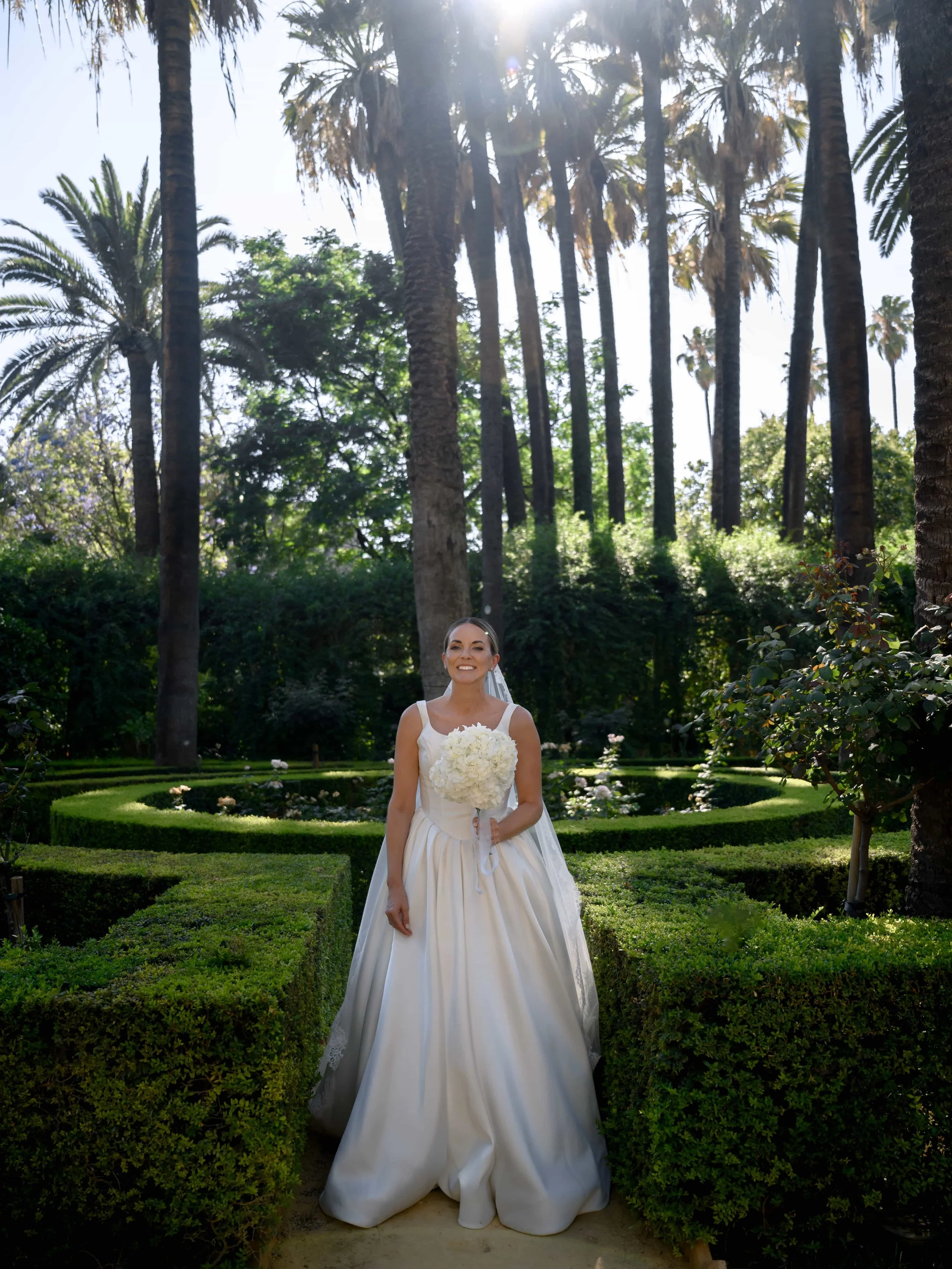 bride shooting in the garden with palm trees 