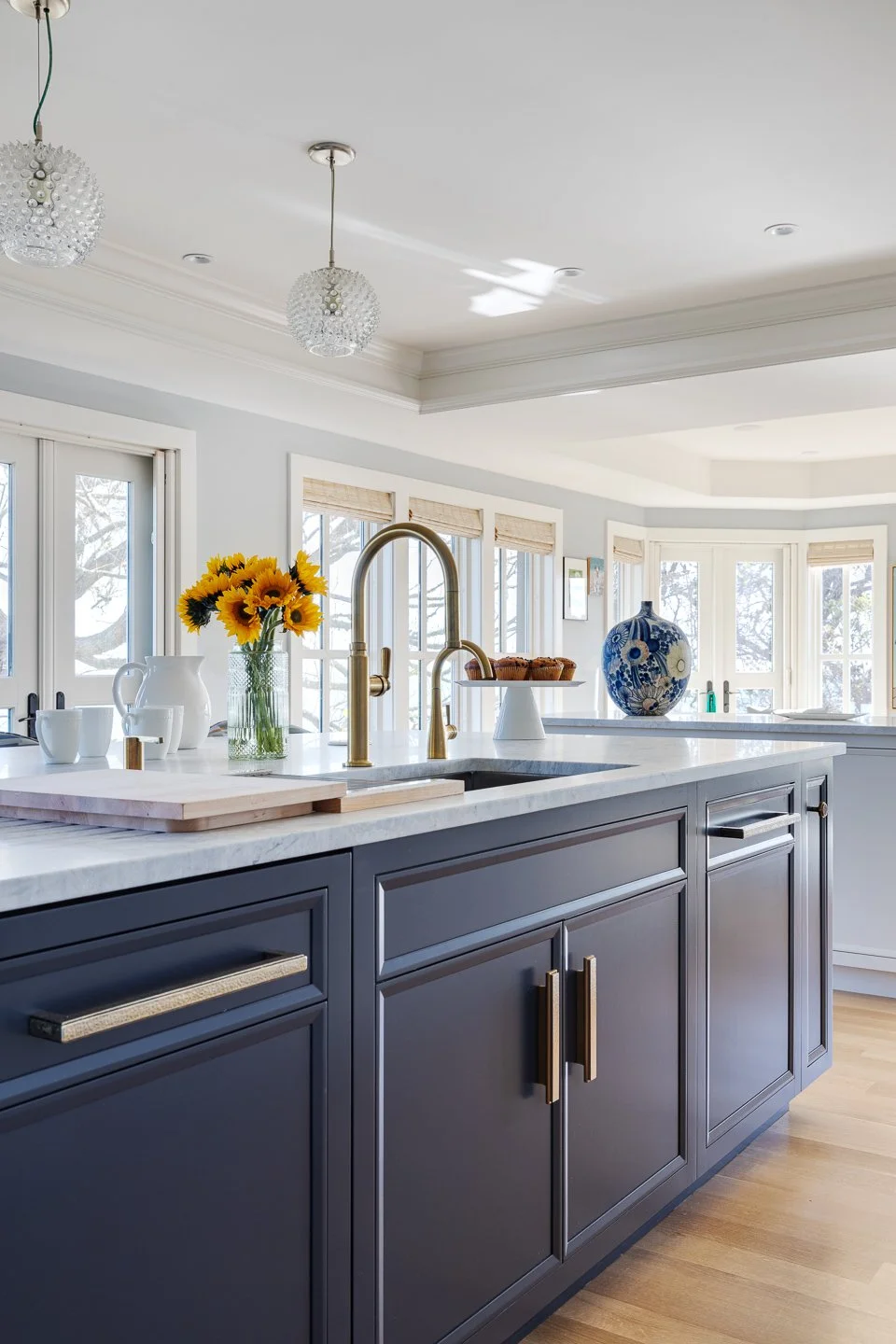 navy island with brass hardware and quartzite countertops