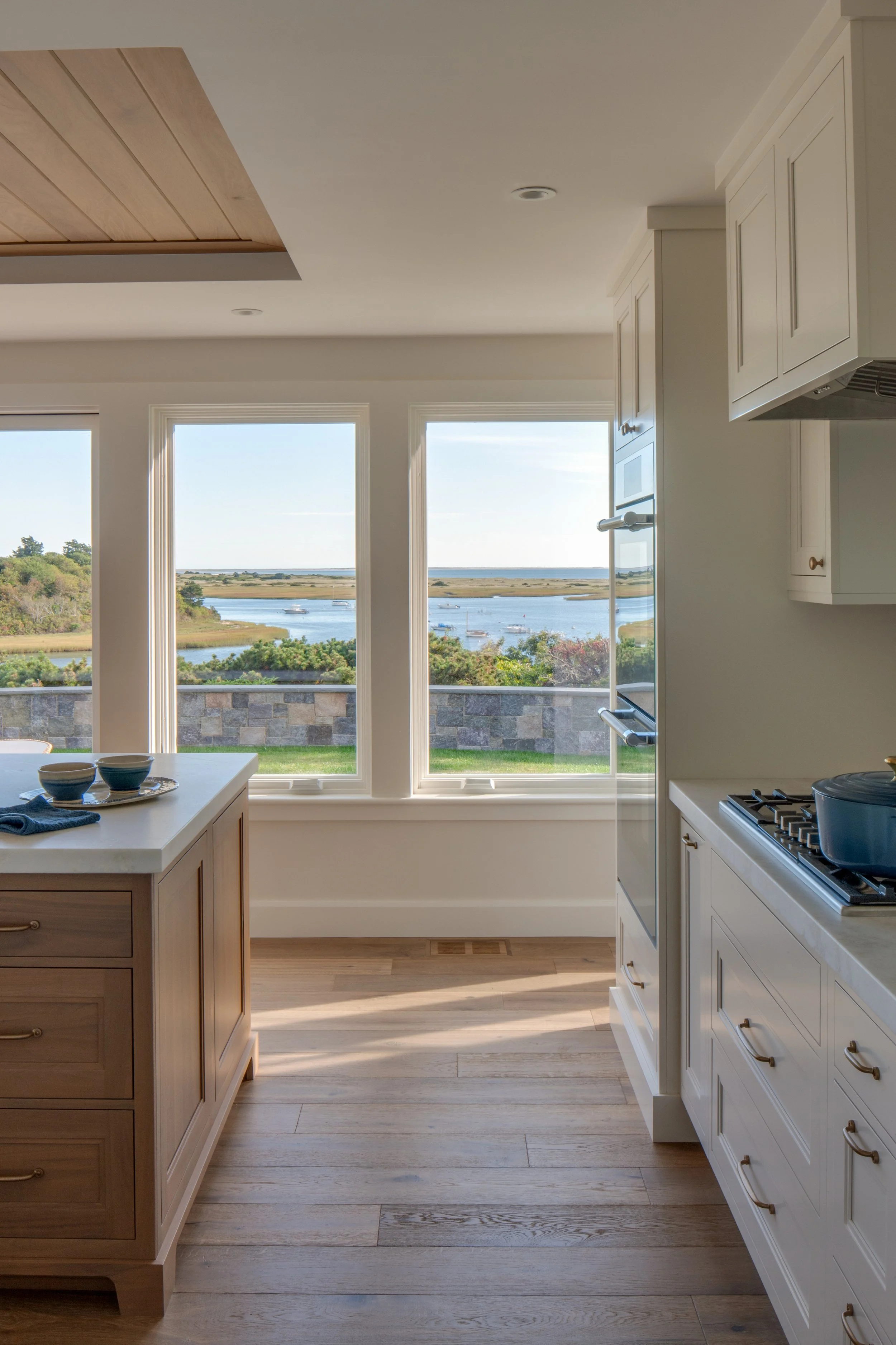 waterfront coastal kitchen cabinetry with brass hardware, white cabinets