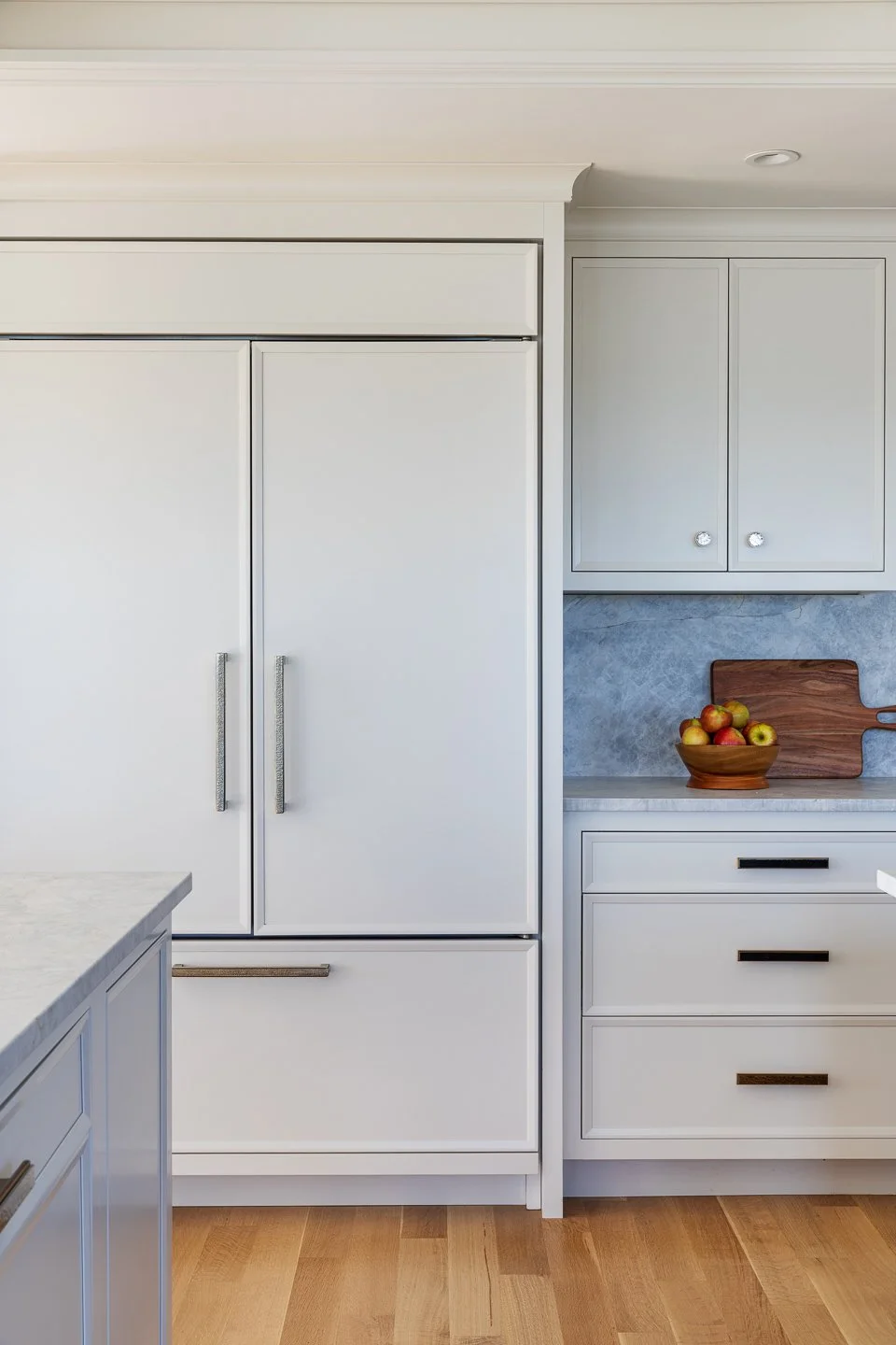 high quality white cabinetry and appliance panels and full height backsplash