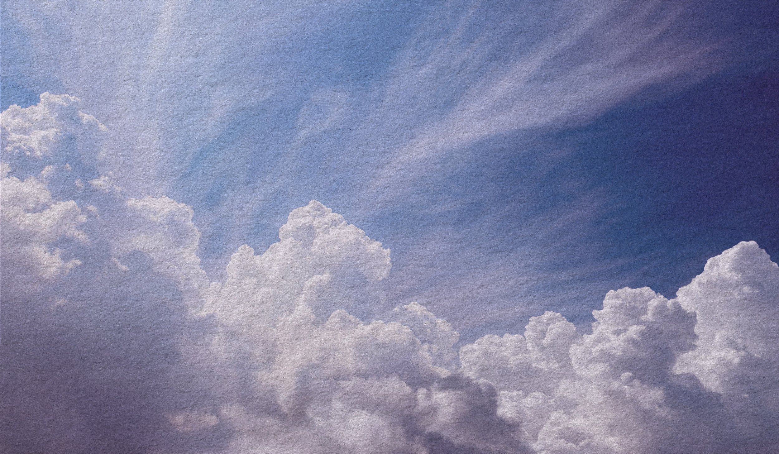 Sky with scattered fluffy white clouds and a gradient blue background.