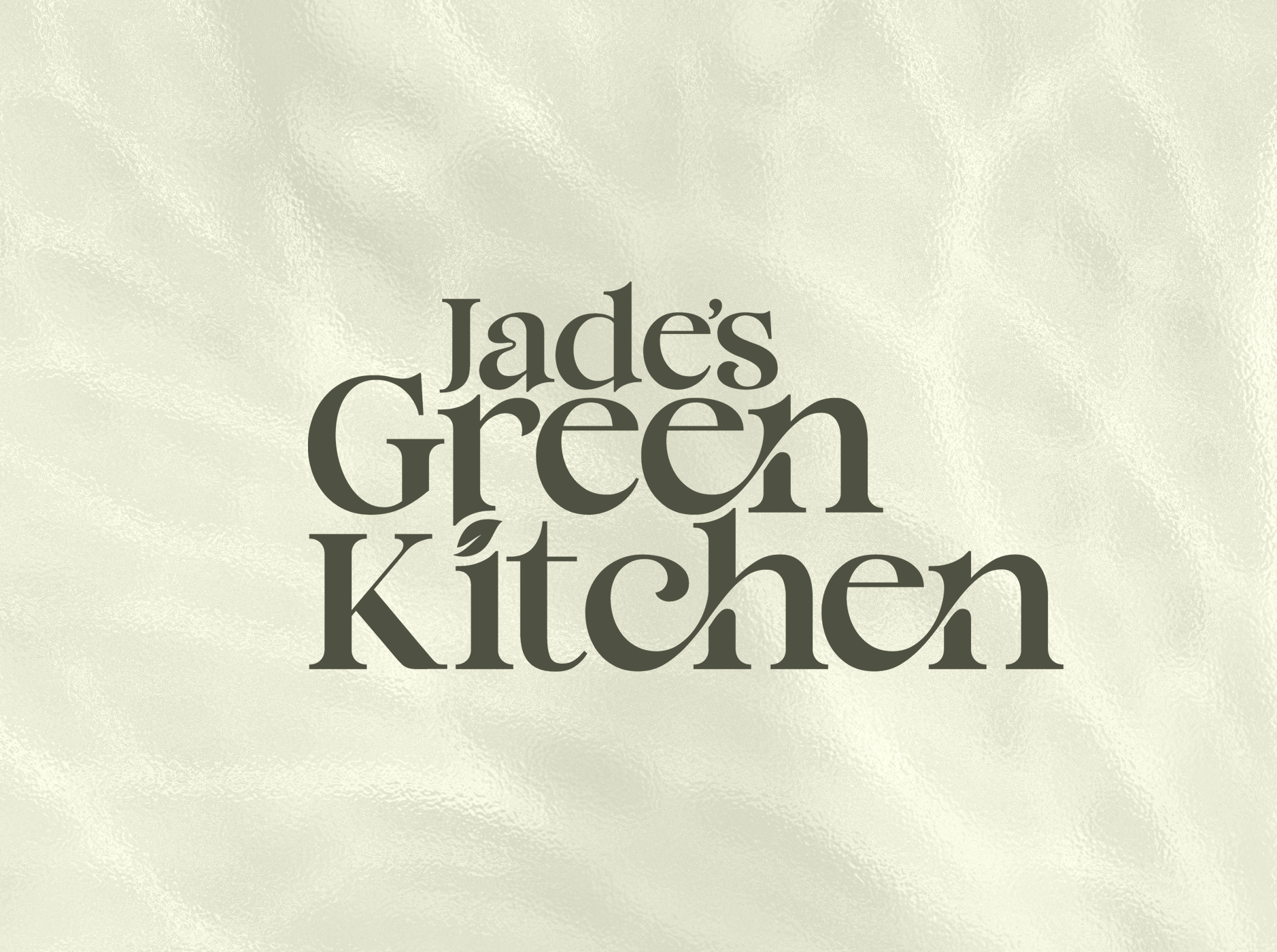 Logo with the text "Jade's Green Kitchen" in decorative font on a textured background.