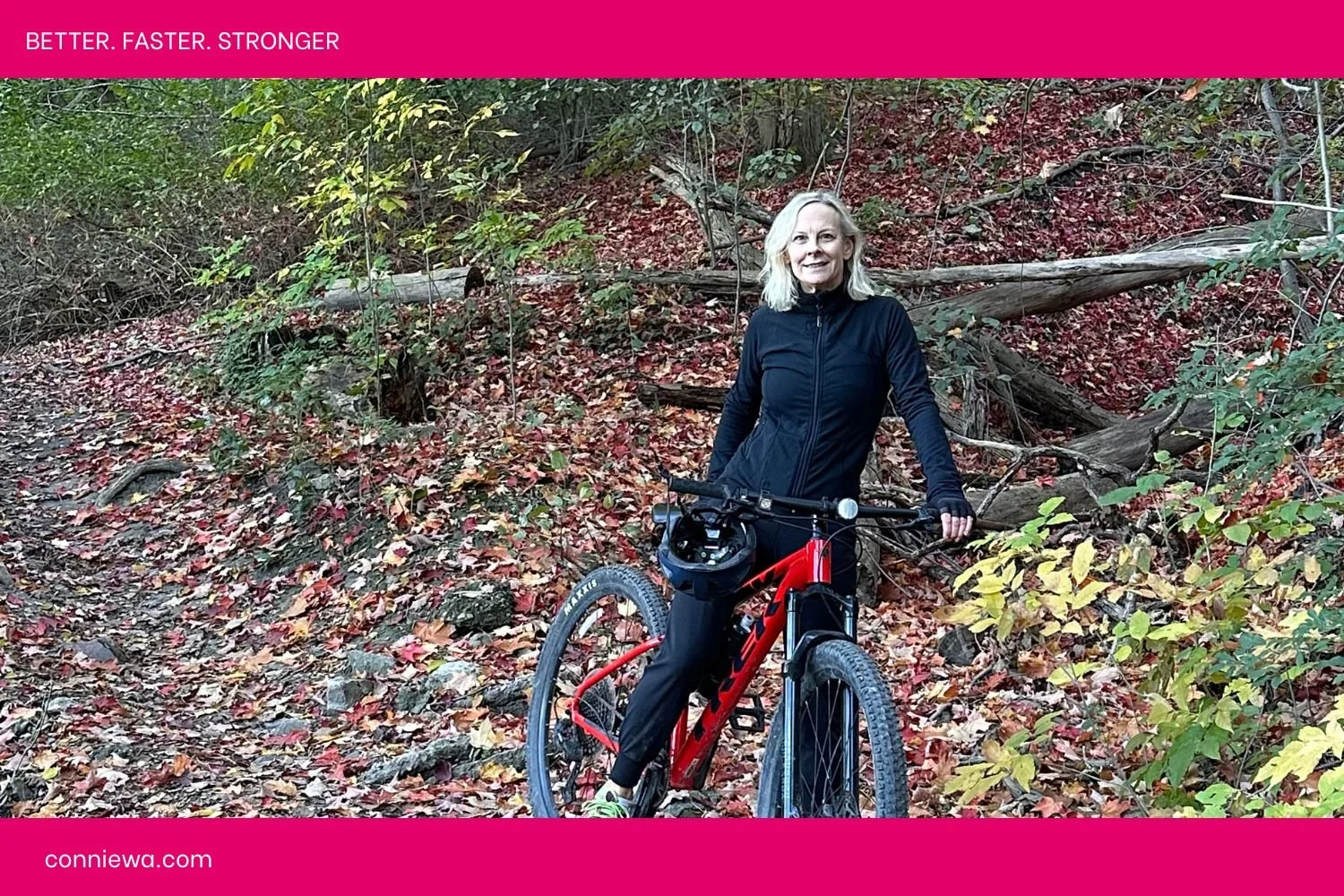 Connie on bike on a trail in the fall leaves