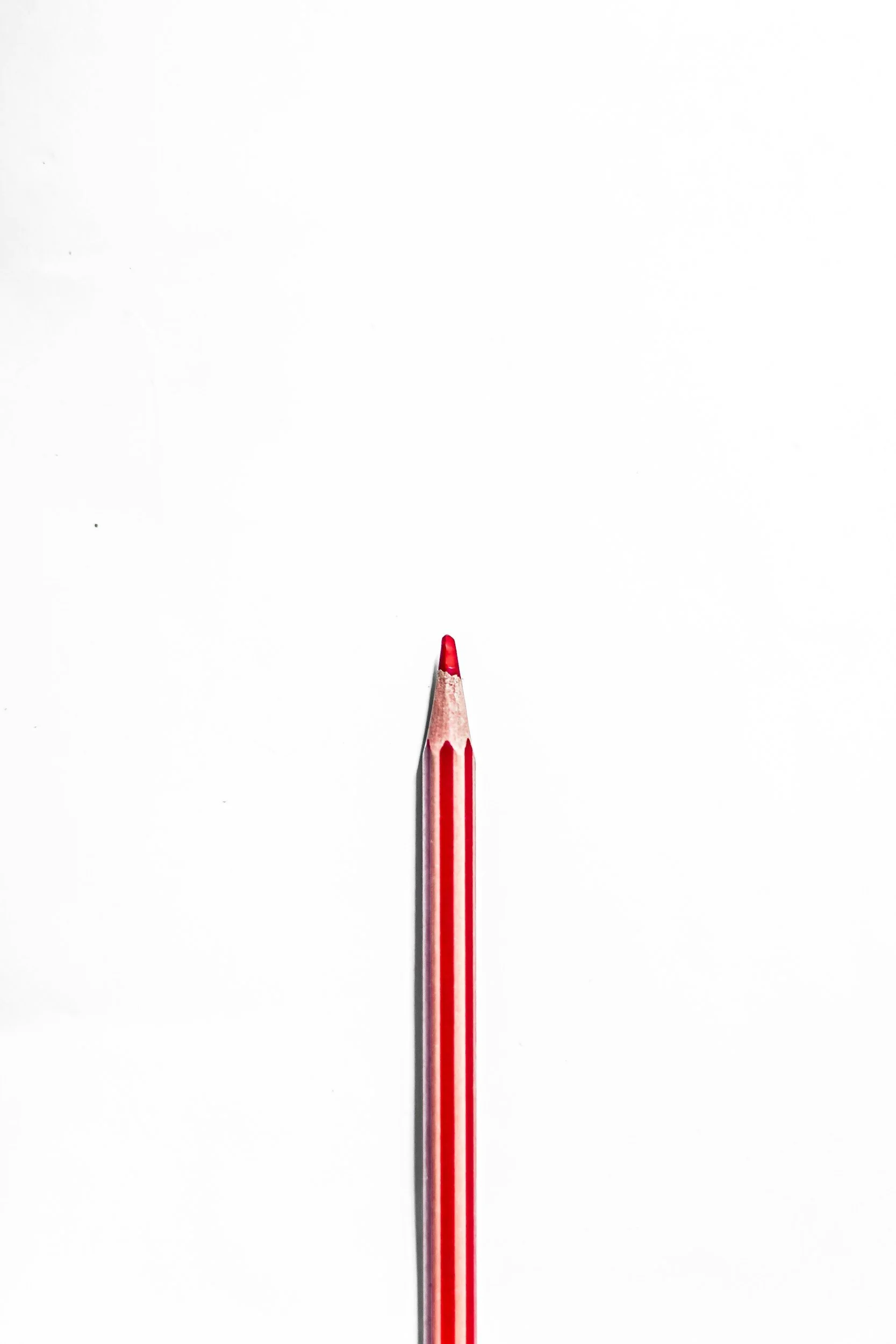 Red pencil on cream background