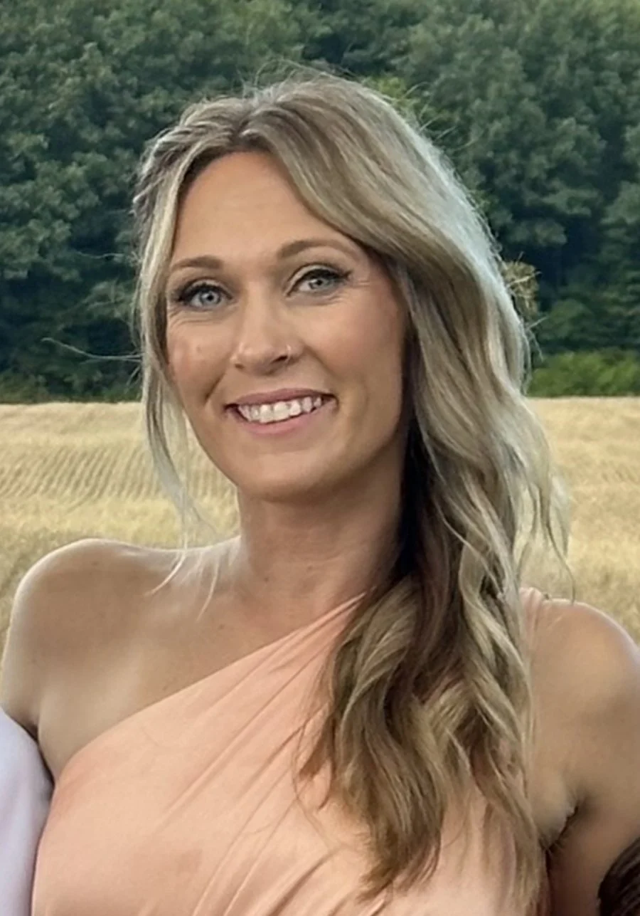 Letter tiles spelling 'Coming Soon' on a white surface with eucalyptus leaves.