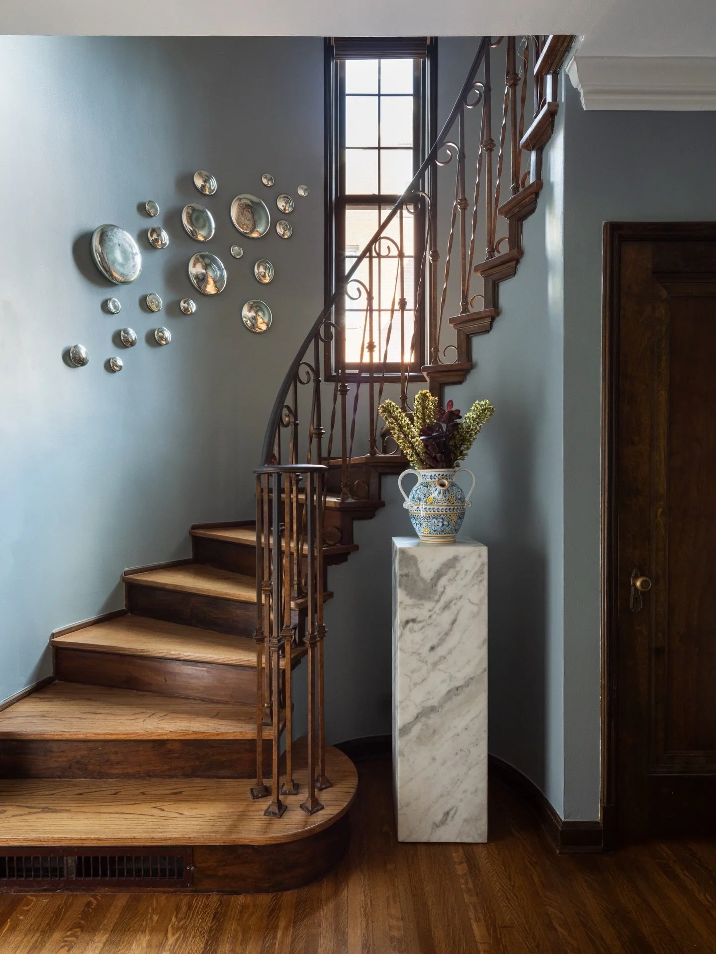 This historic Tudor home has a fairytale feel to it, with it&rsquo;s dark wood floors and trims, twirling staircase, arched windows and intricate door openings. I could go on and on! The foyer at our #MemorialTudor project checked all of the classic 