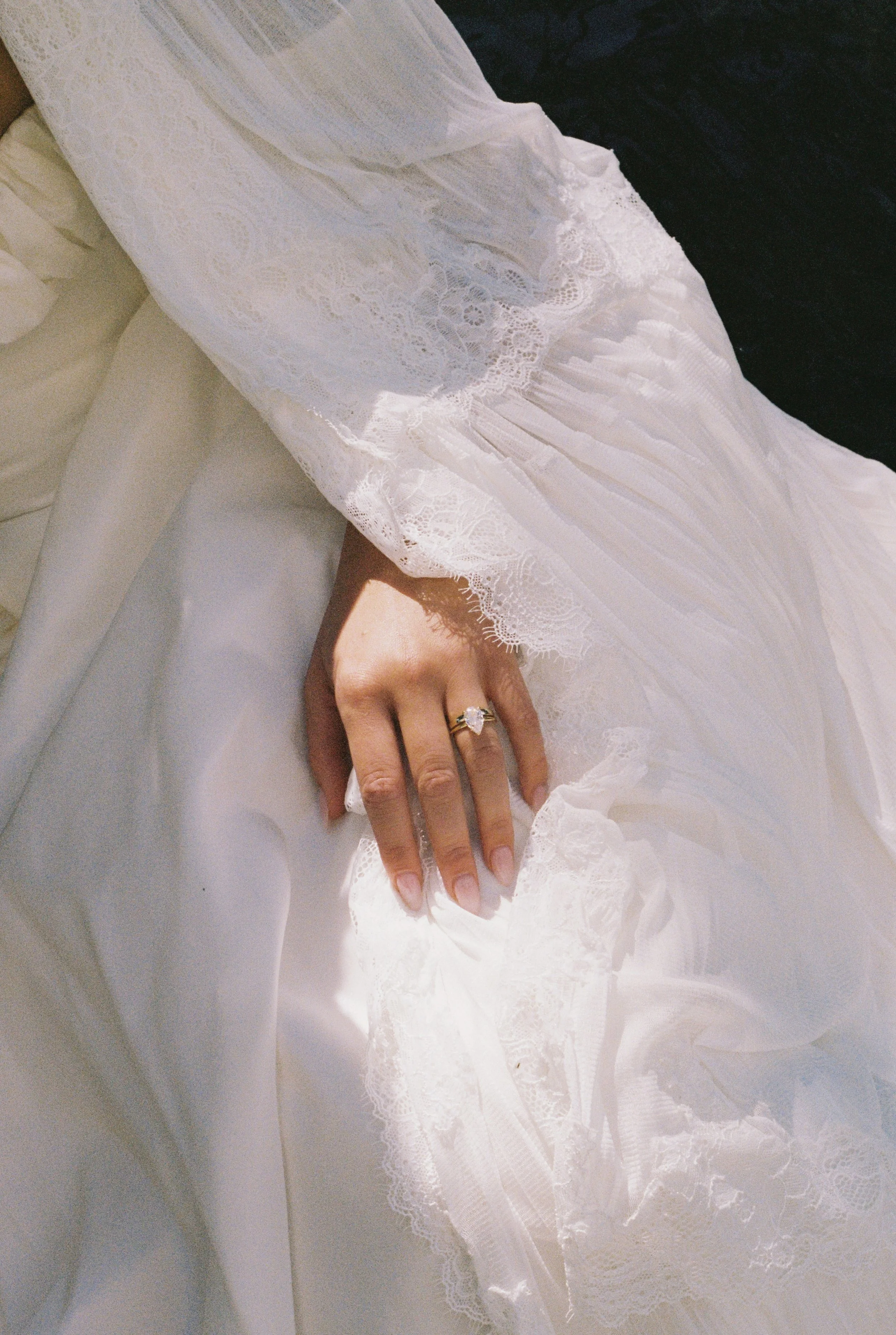 Bride’s engagement ring and lace wedding dress detail at a Provence destination wedding.
