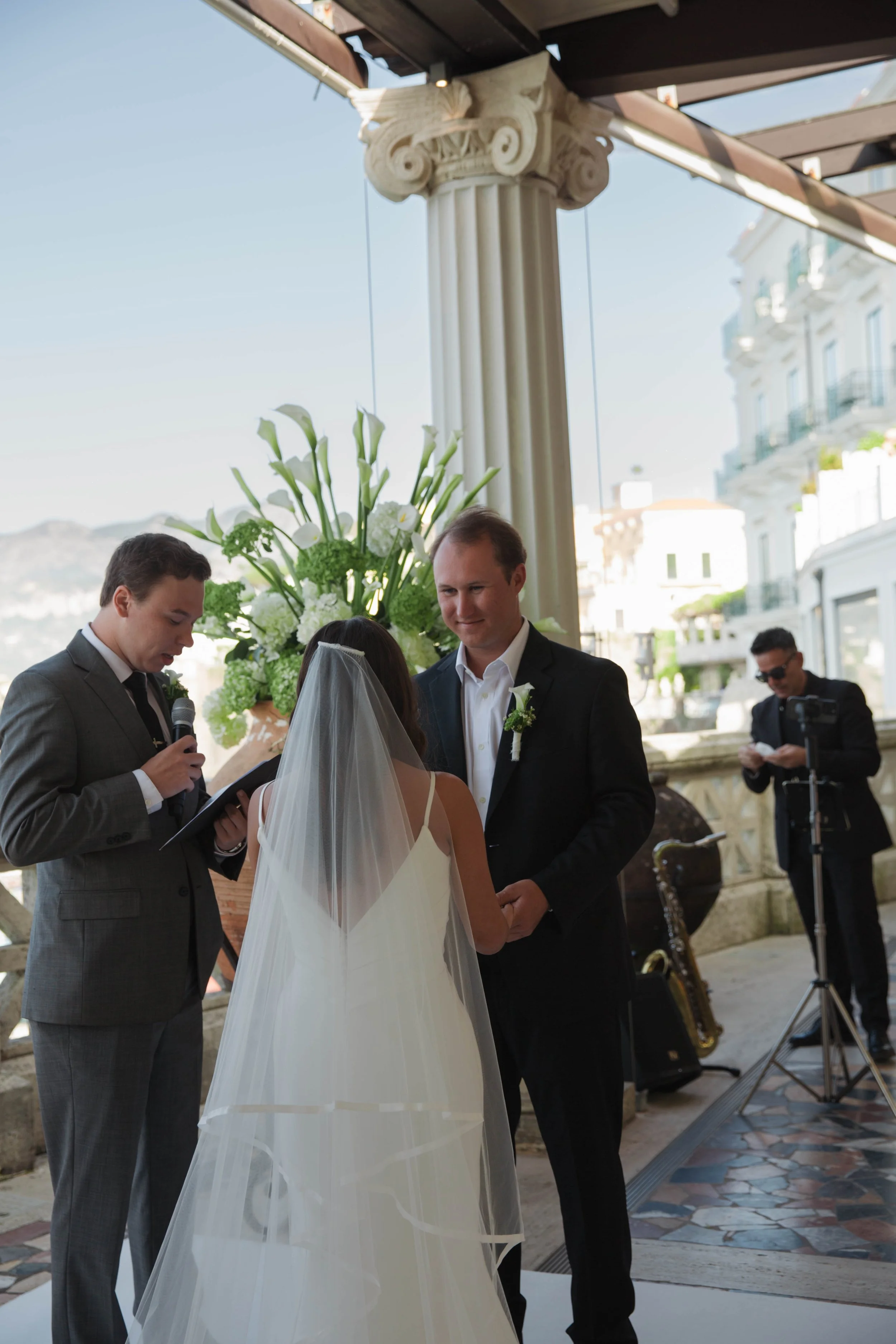 Bride and groom exchanging vows under the columns of the Bellevue Syrene terrace in Sorrento