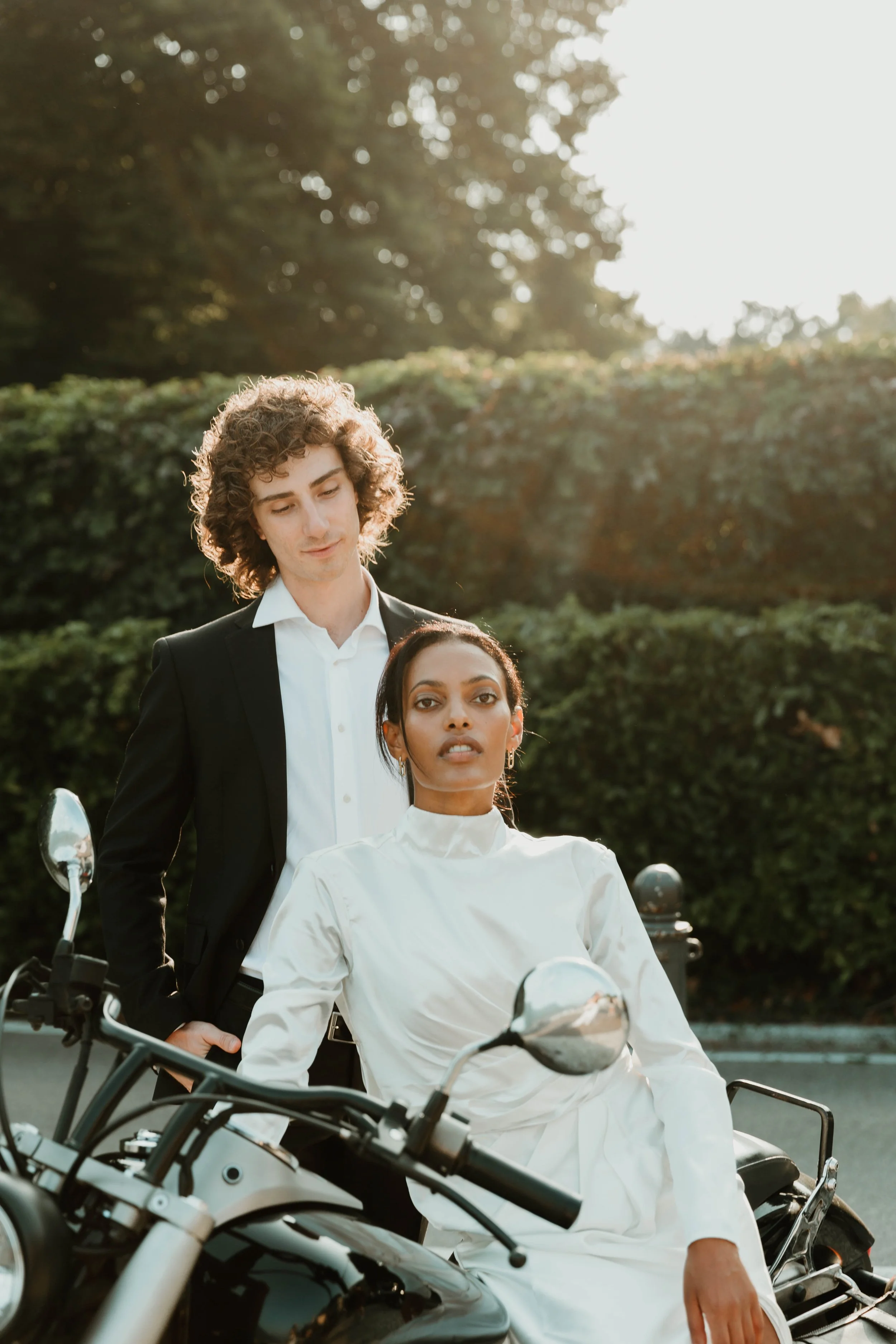 Couple posing with a motorcycle during their Lake Como elopement editorial in Cernobbio