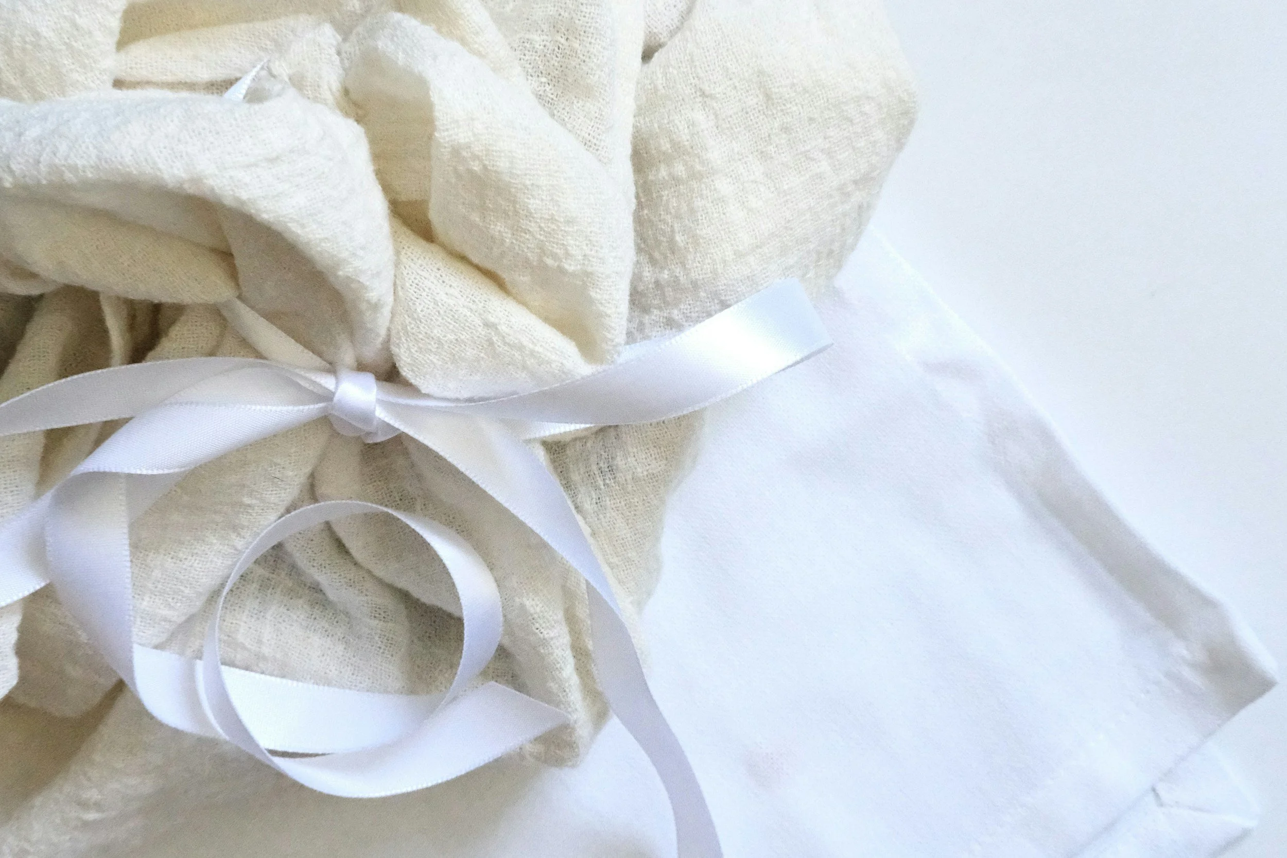 white ribbon tied around cream colored linen fabric image for "Am I Autistic, or Is It Trauma?" from Amanda Morris Therapy
