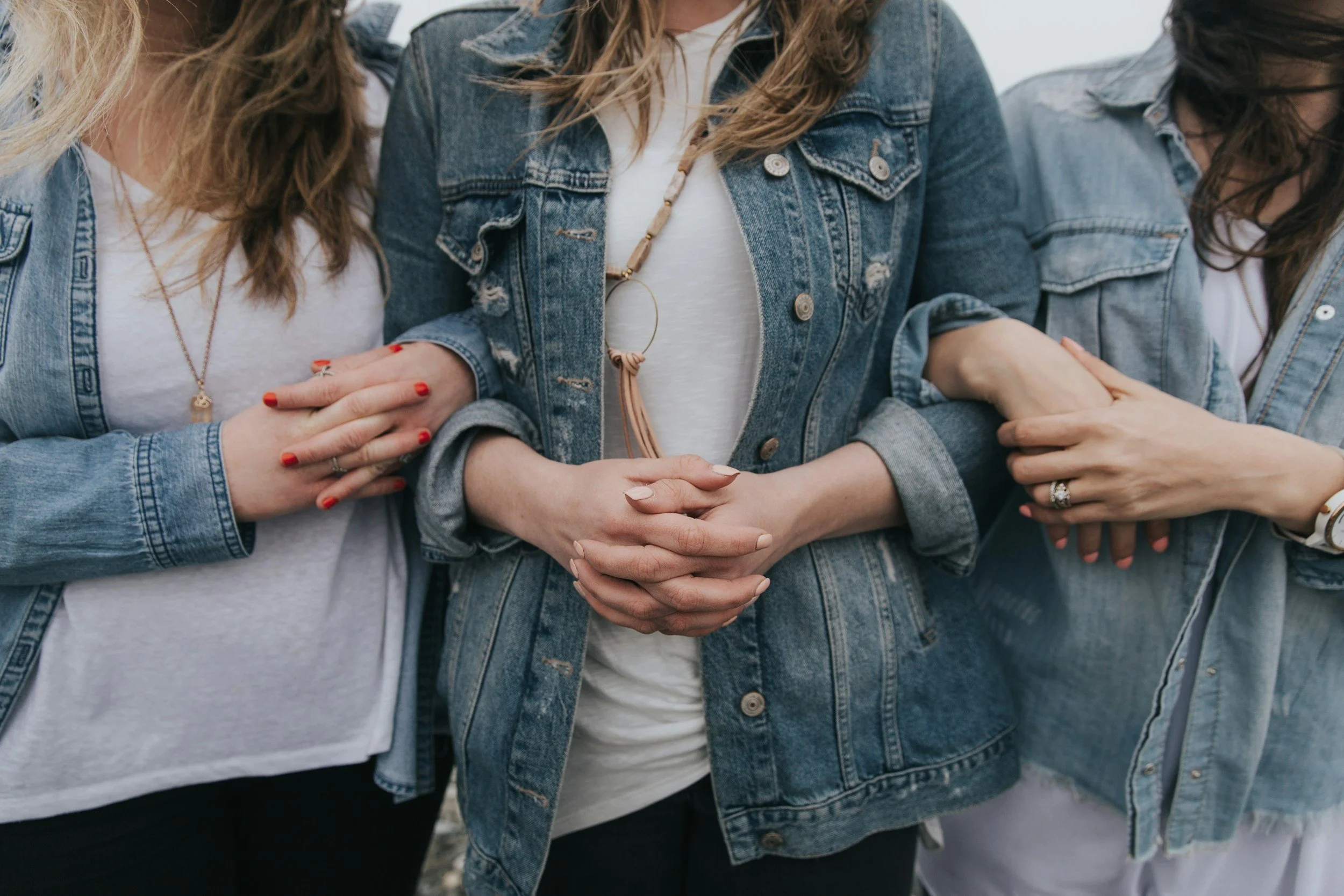 women in jean jackets linking arms after emotional abuse recovery group in baton rouge