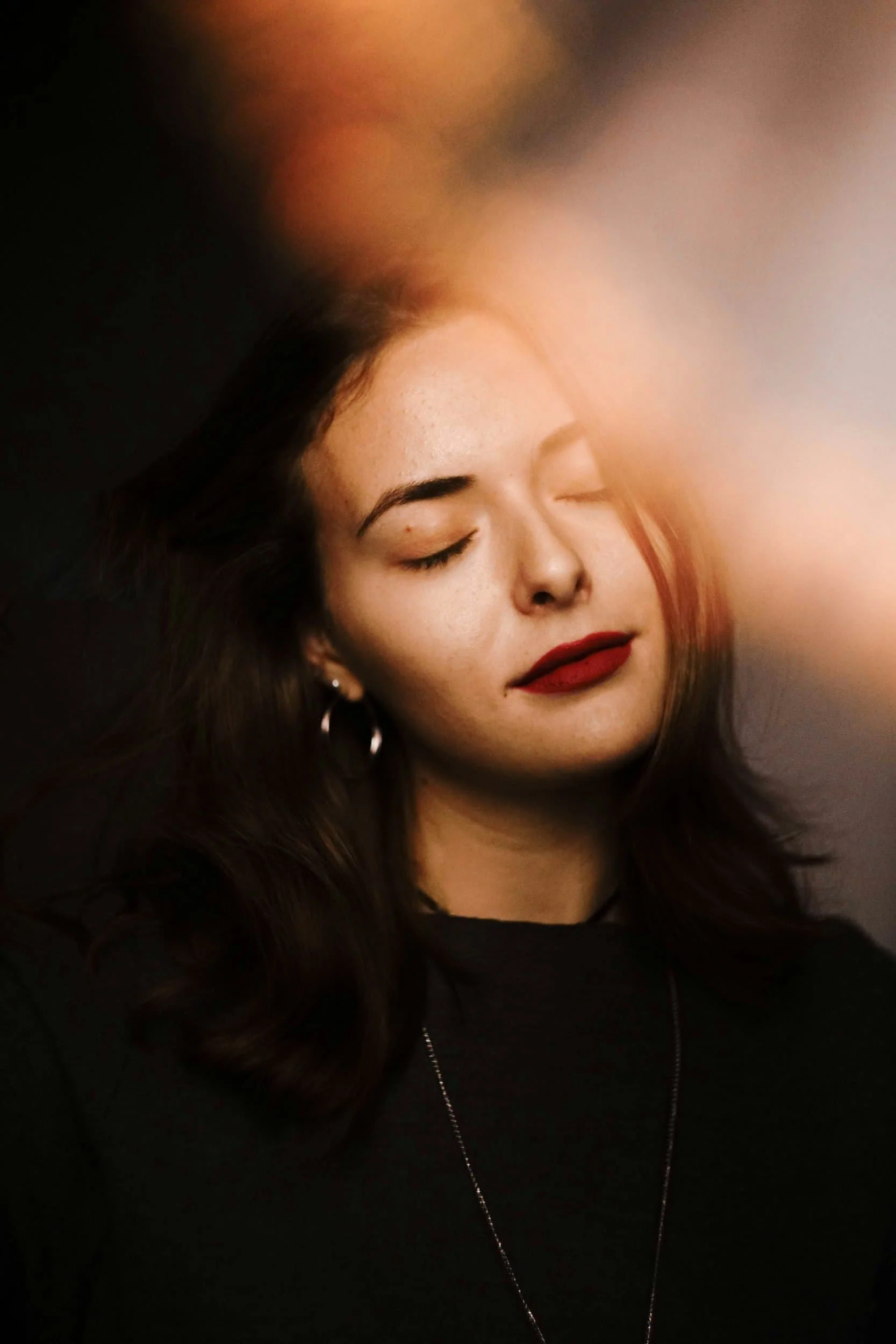 girl long hair red lipstick closing her eyes contemplating