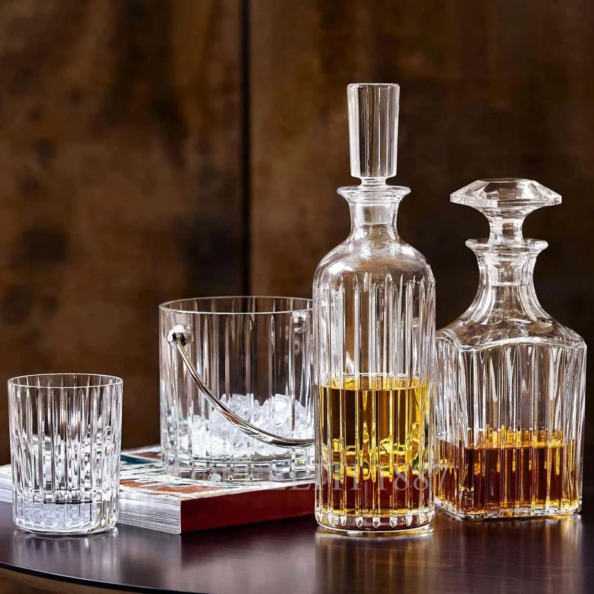 Bar setup with cocktail shaker, jigger, glasses, ice bucket, and bottles
