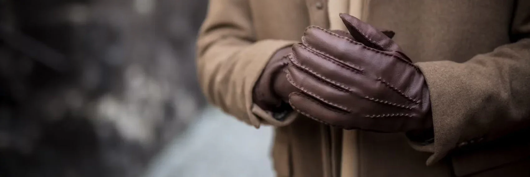 Person wearing red holiday-themed socks with Santa Claus, snowmen, gifts, and candy canes, paired with plaid pants.