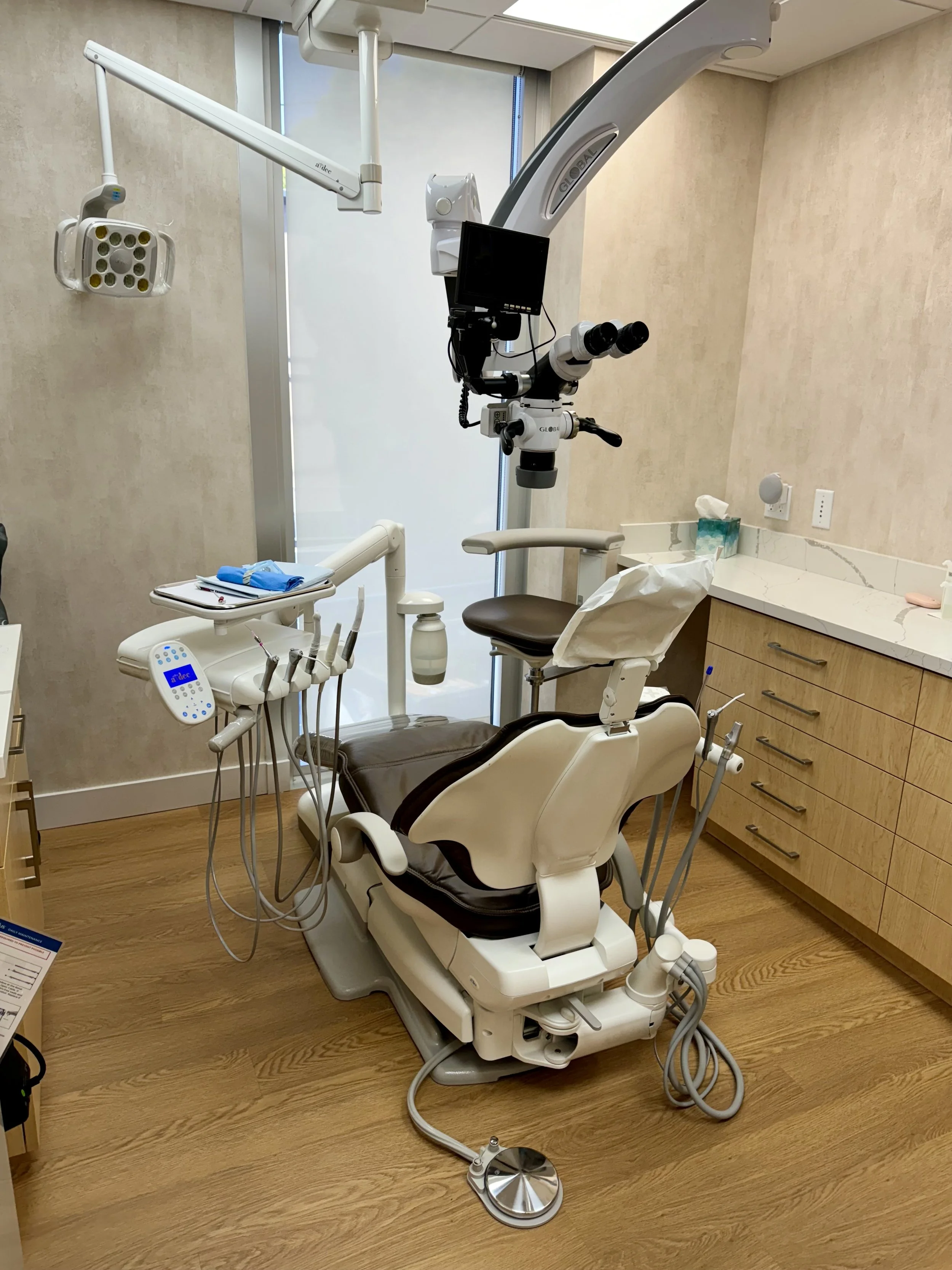 modern endodontic operatory, dental chair, and operating microscope
