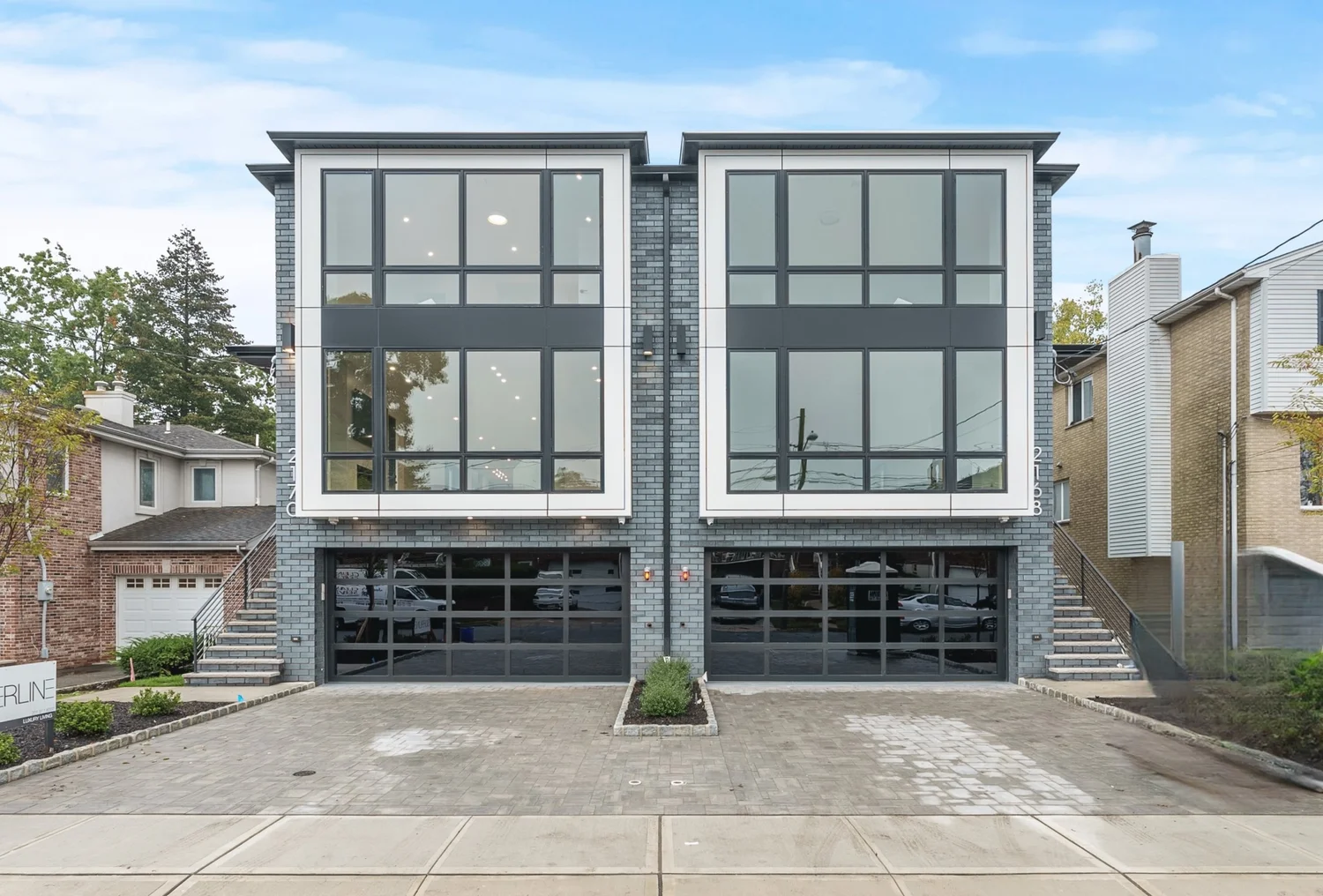 2168 Mackay Ave: two attached modern homes with large windows and glass garage doors