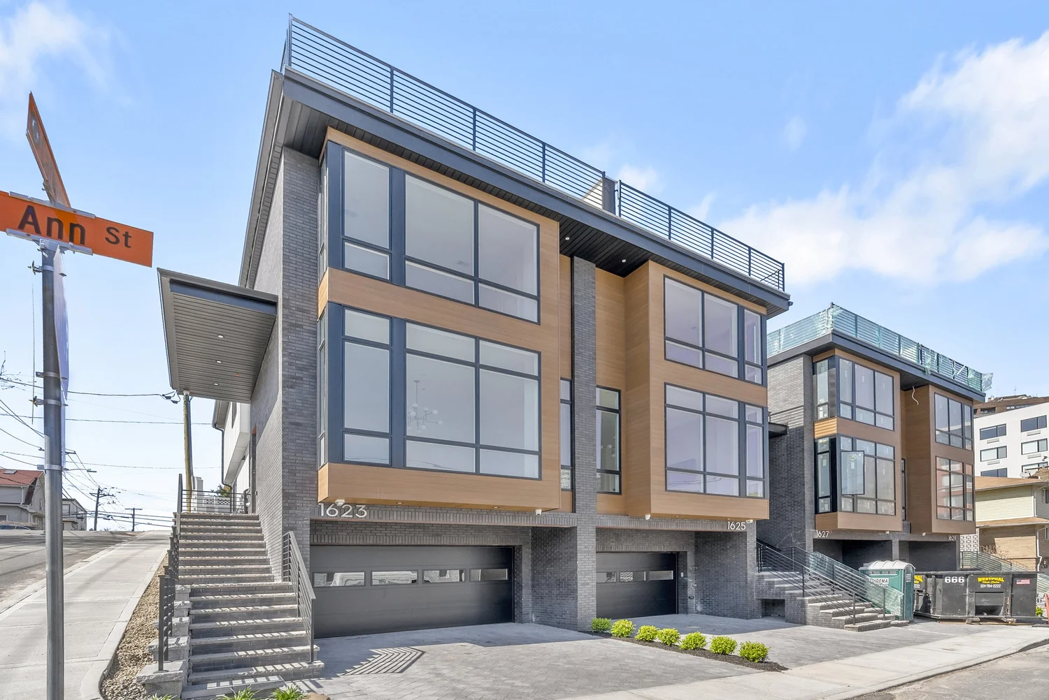 1623-1629 Ann St: corner townhomes with wood-tone cladding and a rooftop terrace