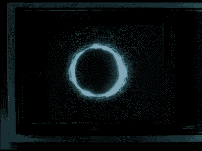 A glowing blue ring or circle on a dark background.