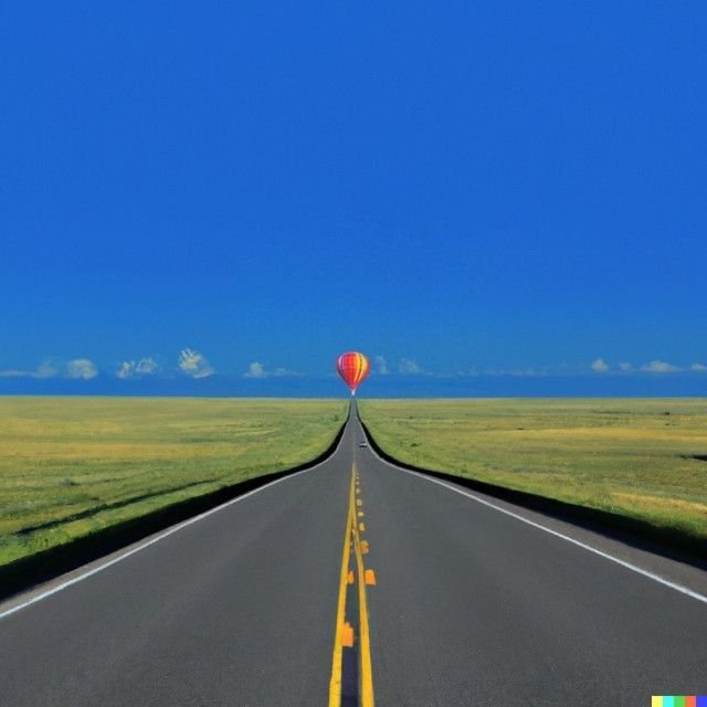 A straight road stretches into the horizon with a hot air balloon floating in the blue sky.