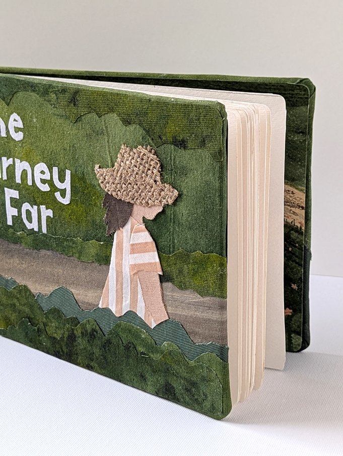 Children's illustrated book with a textured cover, showing a girl with curly hair wearing a striped dress walking along a path surrounded by green bushes and trees.