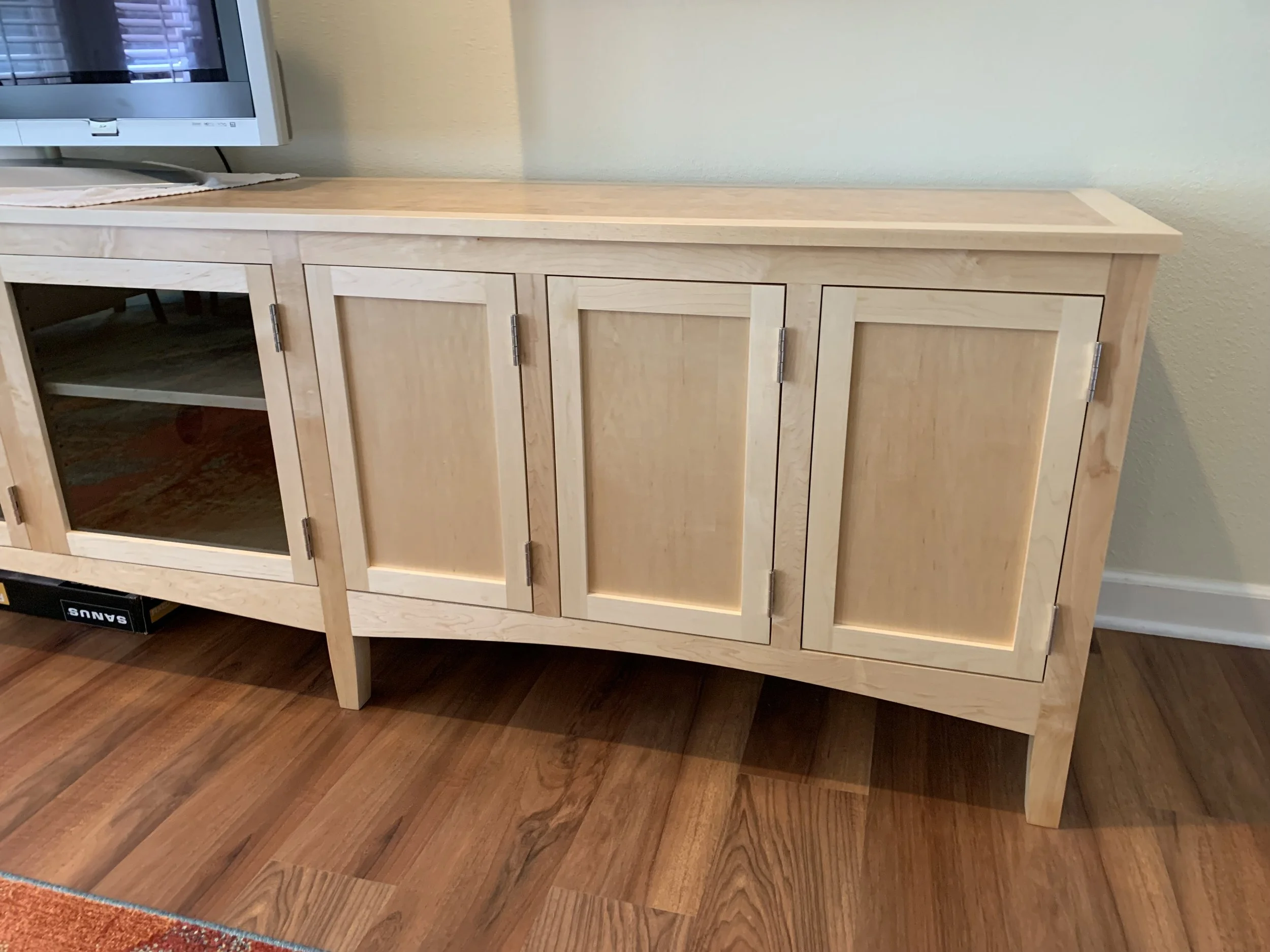Custom design and build of maple media cabinet with curly maple veneer