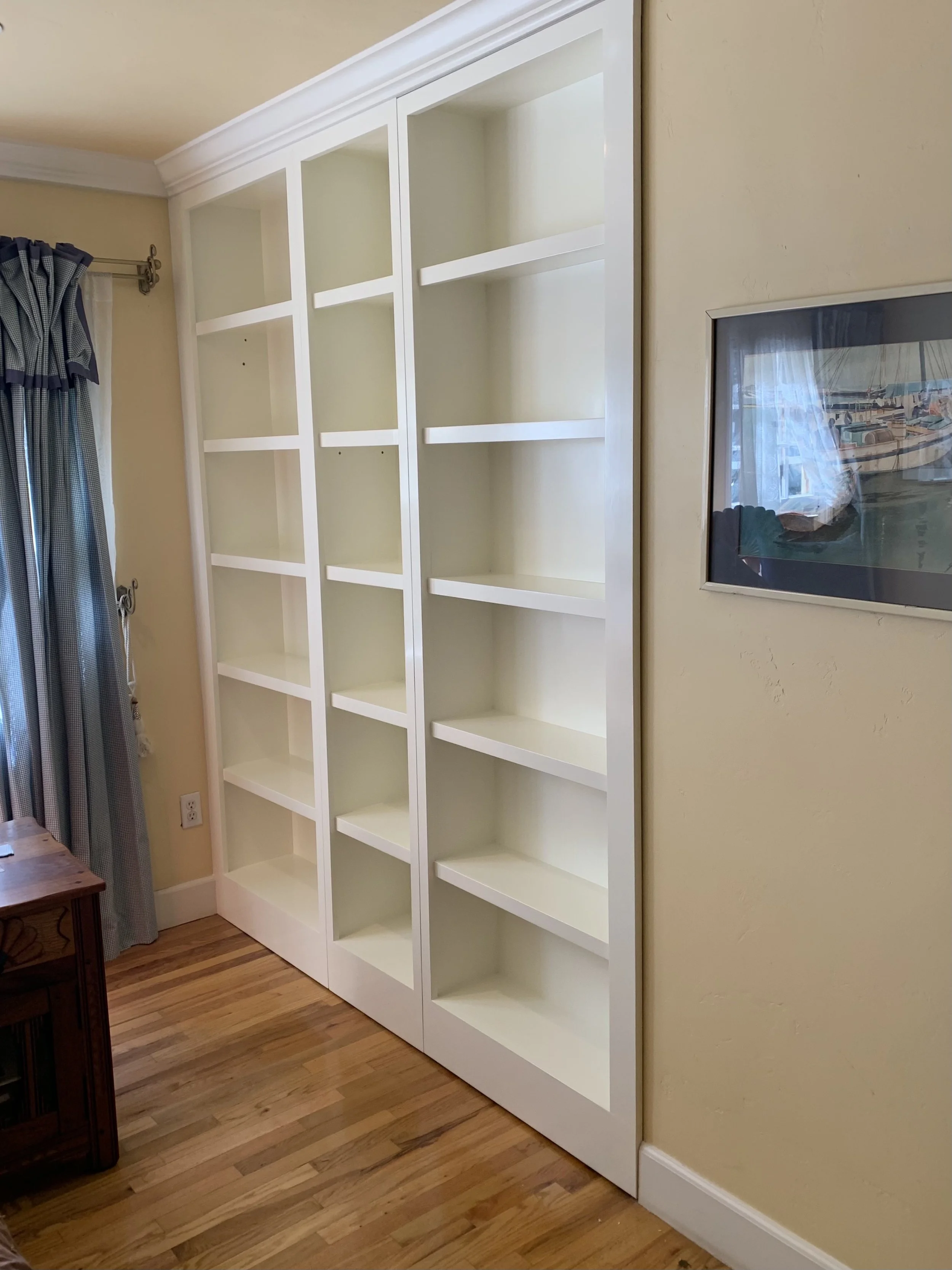 Custom design, build and instal of shelving with hidden door