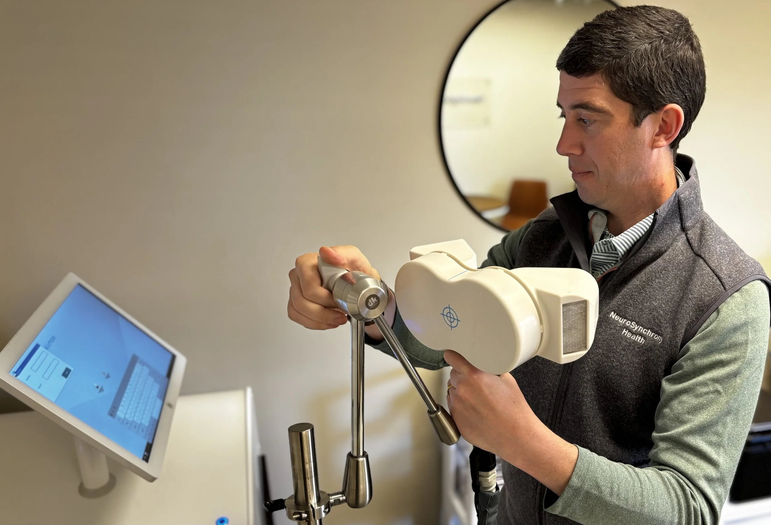 Gregg holds a rtms coil for placement on patient