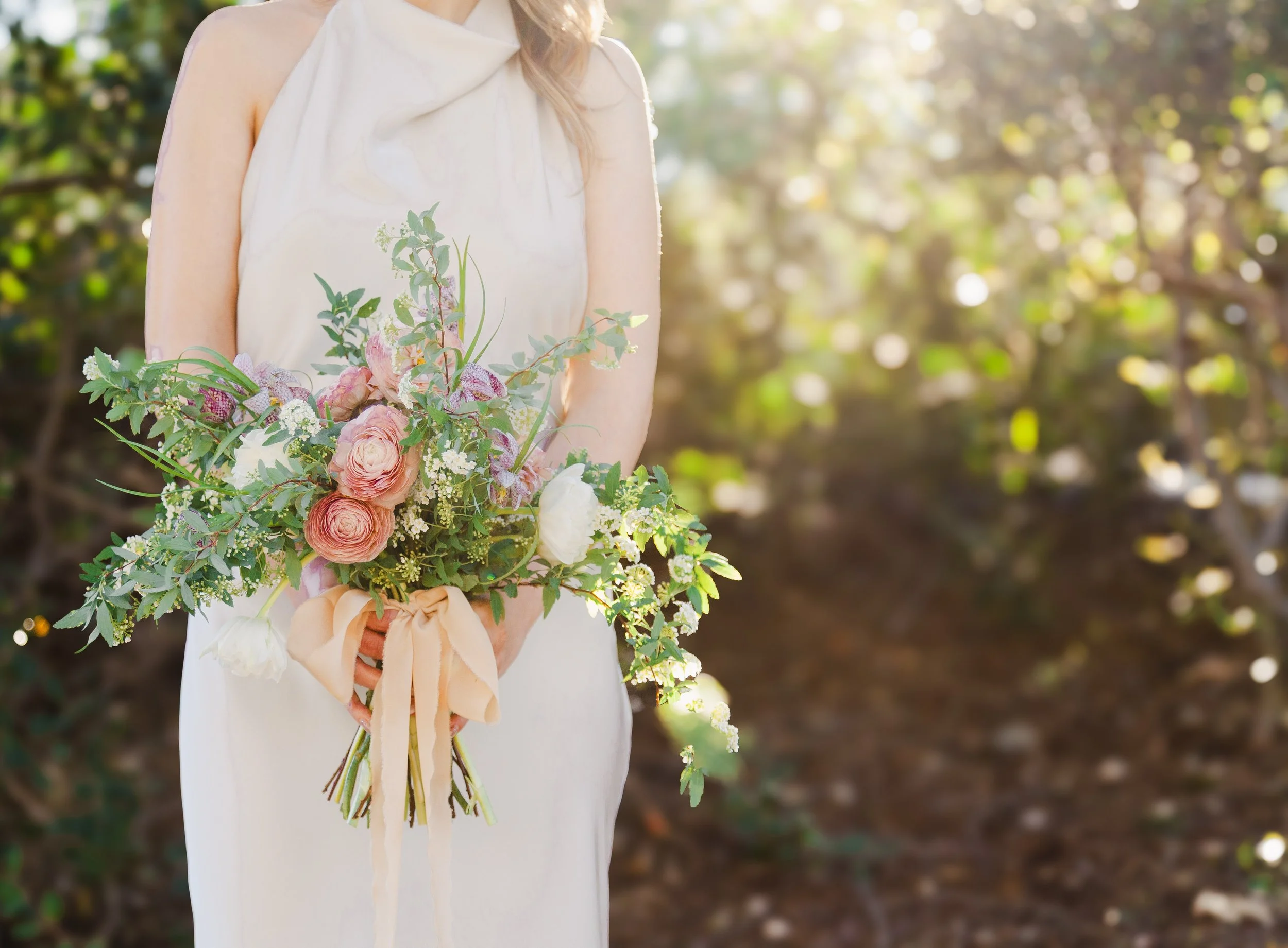 Spring wedding bouquet in Los Angeles Glendale using ranunculus, tulips, spirea blooming branches frittilaria