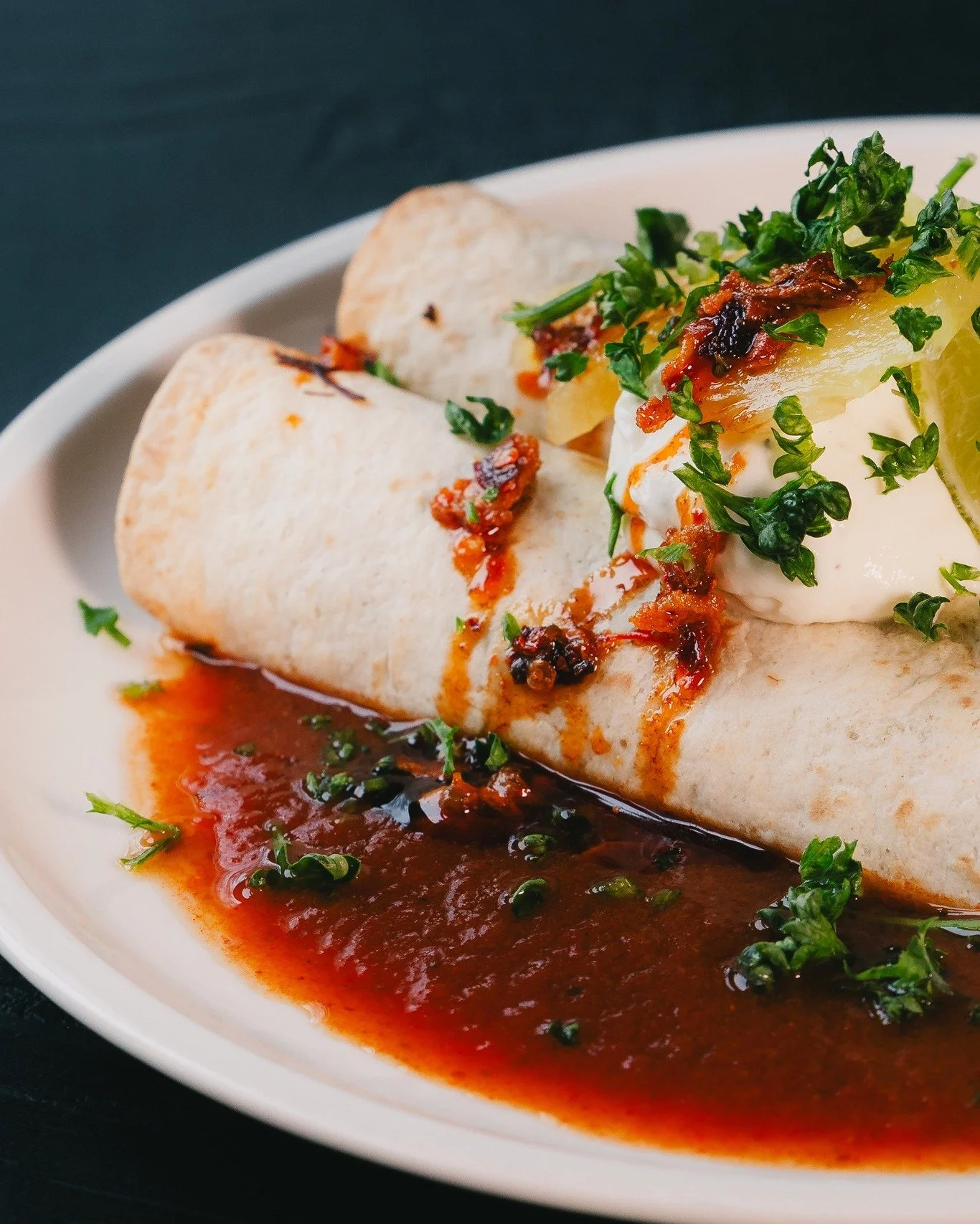 Zie je die rode saus? 👀 Dat is onze slow-cooked consum&eacute; waar we de Birria in serveren. Met super sappige ox cheeks in een mais tortilla, Tommy's BBQ chili crisp, limoen room en gefermenteerde ananas. 

OX CHEEK BIRRIA - nu op het menu!