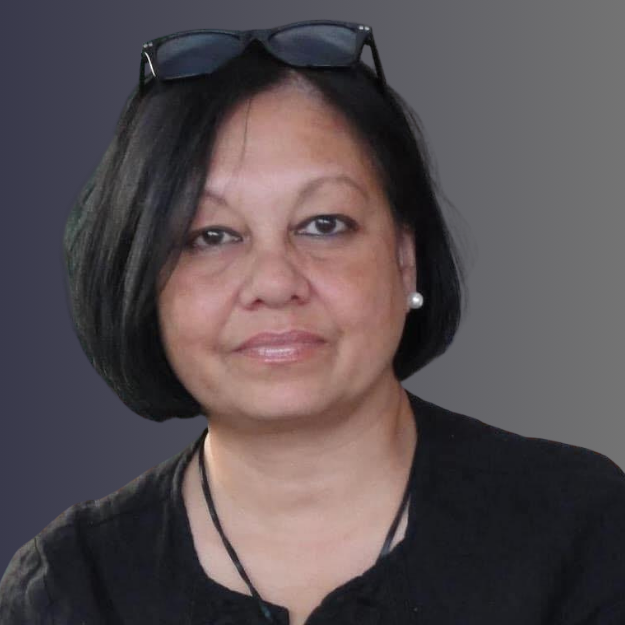 A black-and-white portrait of a woman with short hair, wearing pearl earrings, a necklace, and glasses resting on her head, with a neutral background.