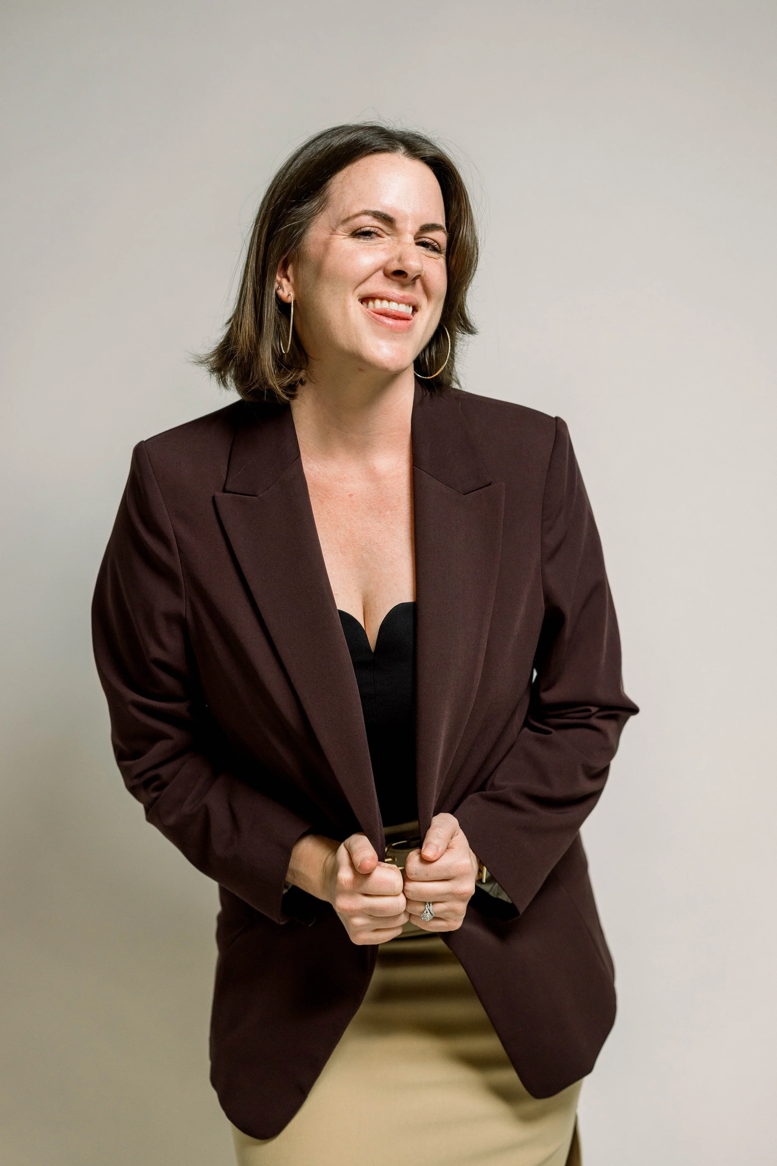 Steph Rubio, Business Growth Strategist, smiling in a dark blazer against a neutral background.