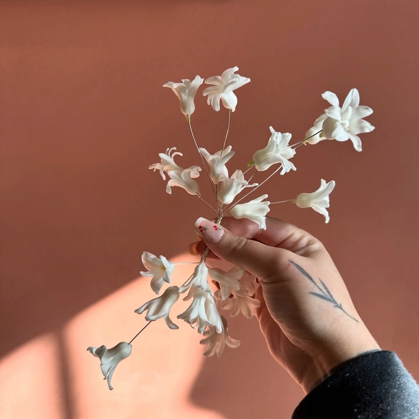 corsage, mid-thought 

a reminder that play is part of the process 
that not everything needs to be perfect to be beautiful 
sometimes the in-between stage is where the magic sits 
petals moving, ideas shifting, hands figuring it out 

before the rib
