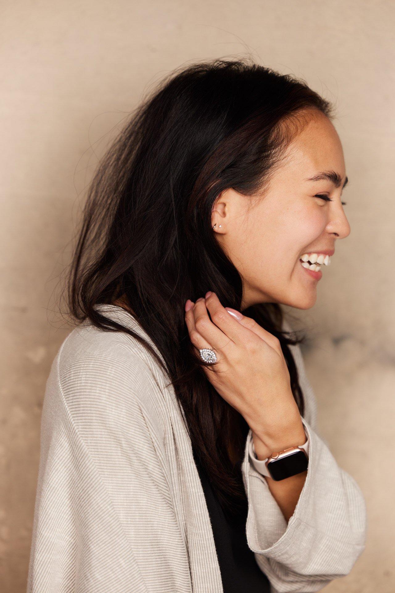 High school senior laughing in profile, photographed in soft natural light at The Portrait Lab in Franklin TN