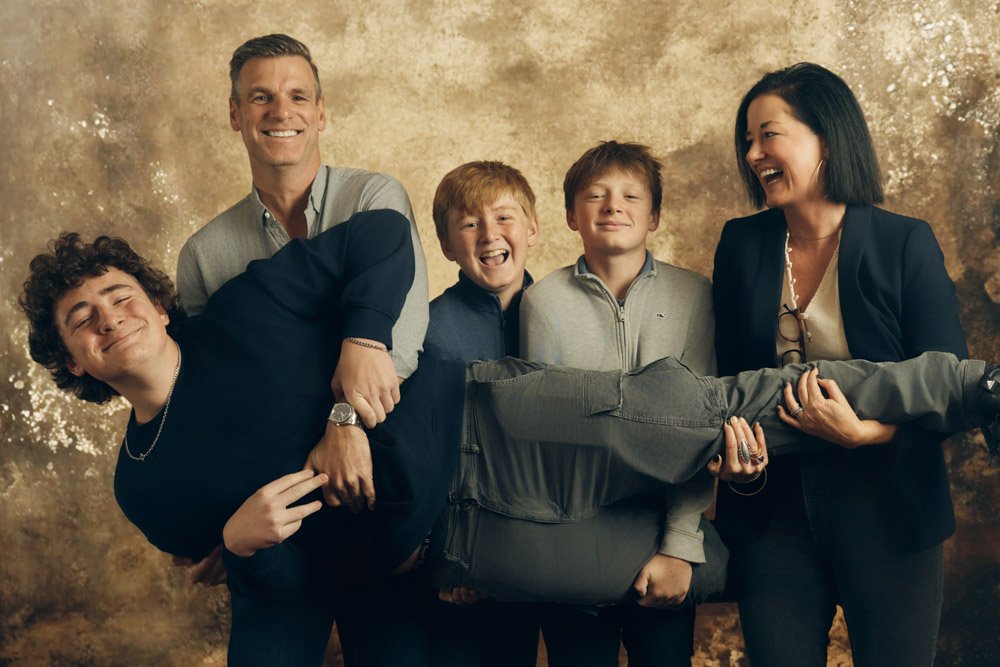 Relaxed studio family portrait with natural expressions
