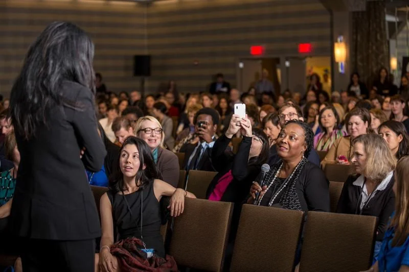 A woman in the audience asking a question.