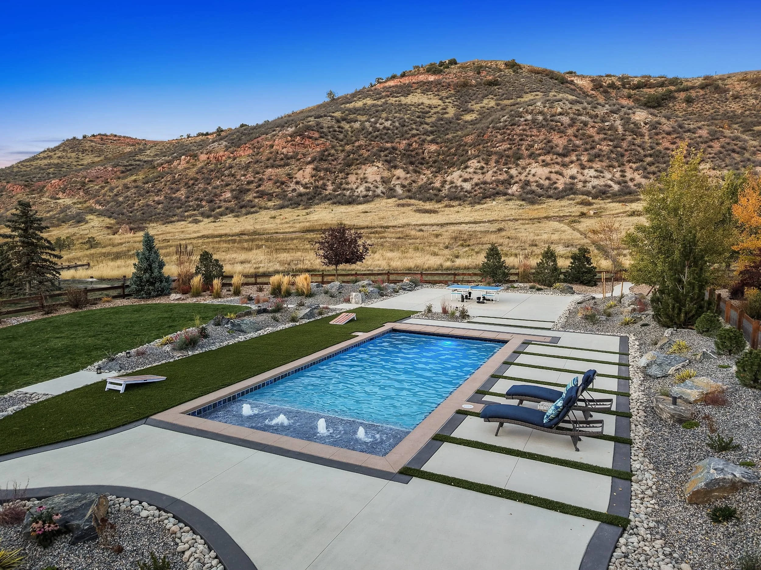 Pool with patio design creating a seamless outdoor living space in Evergreen, CO