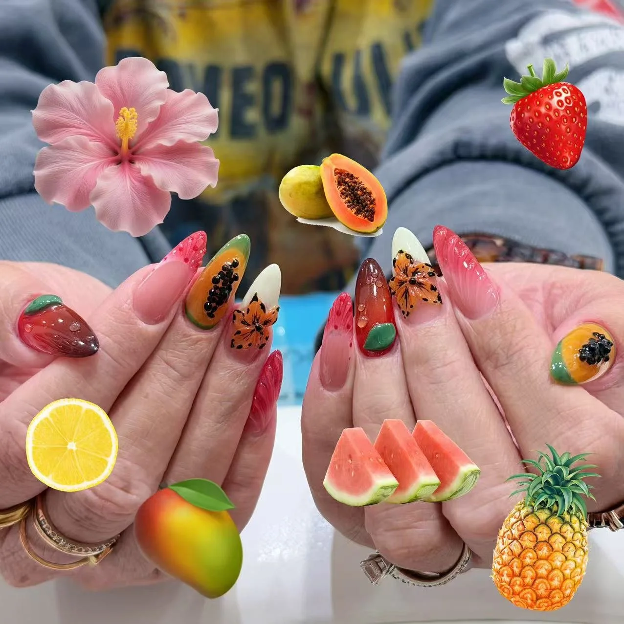Playful summer nail art featuring colorful hand-painted fruit designs.