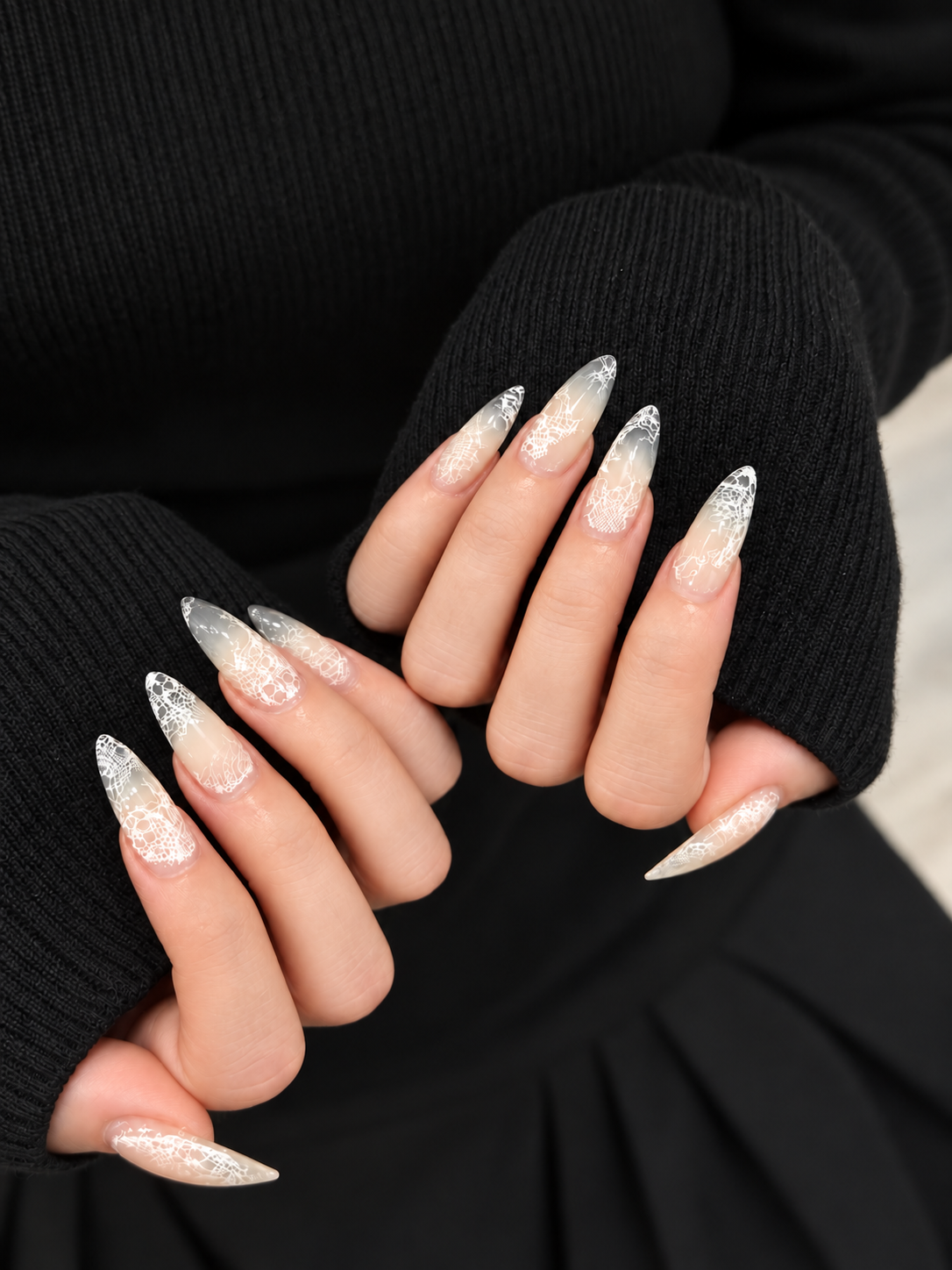 Elegant long nails featuring delicate white lace nail art by Nail of the Day.