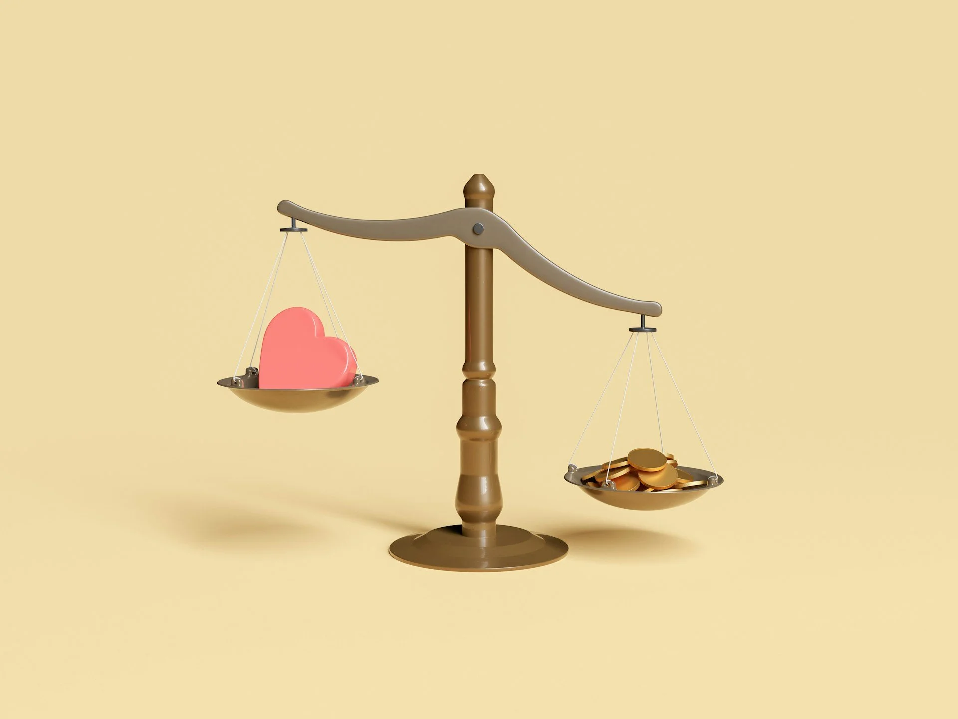 Scale with heart on lighter side and coins on the heavier side
