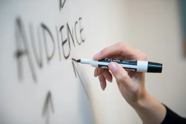 "Audience" with arrows drawn by hand on a whiteboard