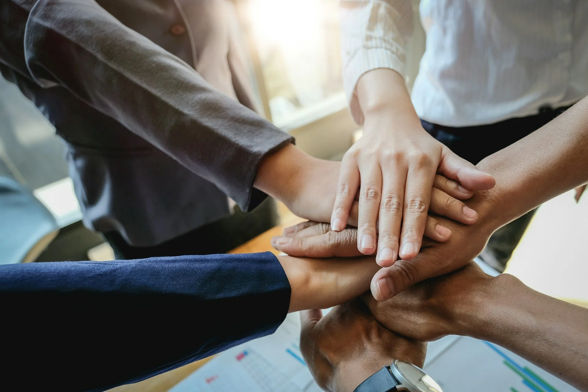 business team joining hands together in the middle