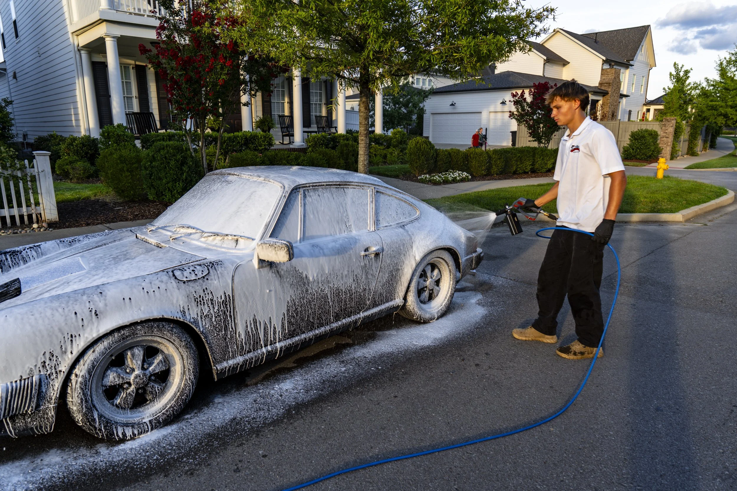 Full-service Porsche detail by Reflections Perfection — residential home with porch in background, Franklin, TN.