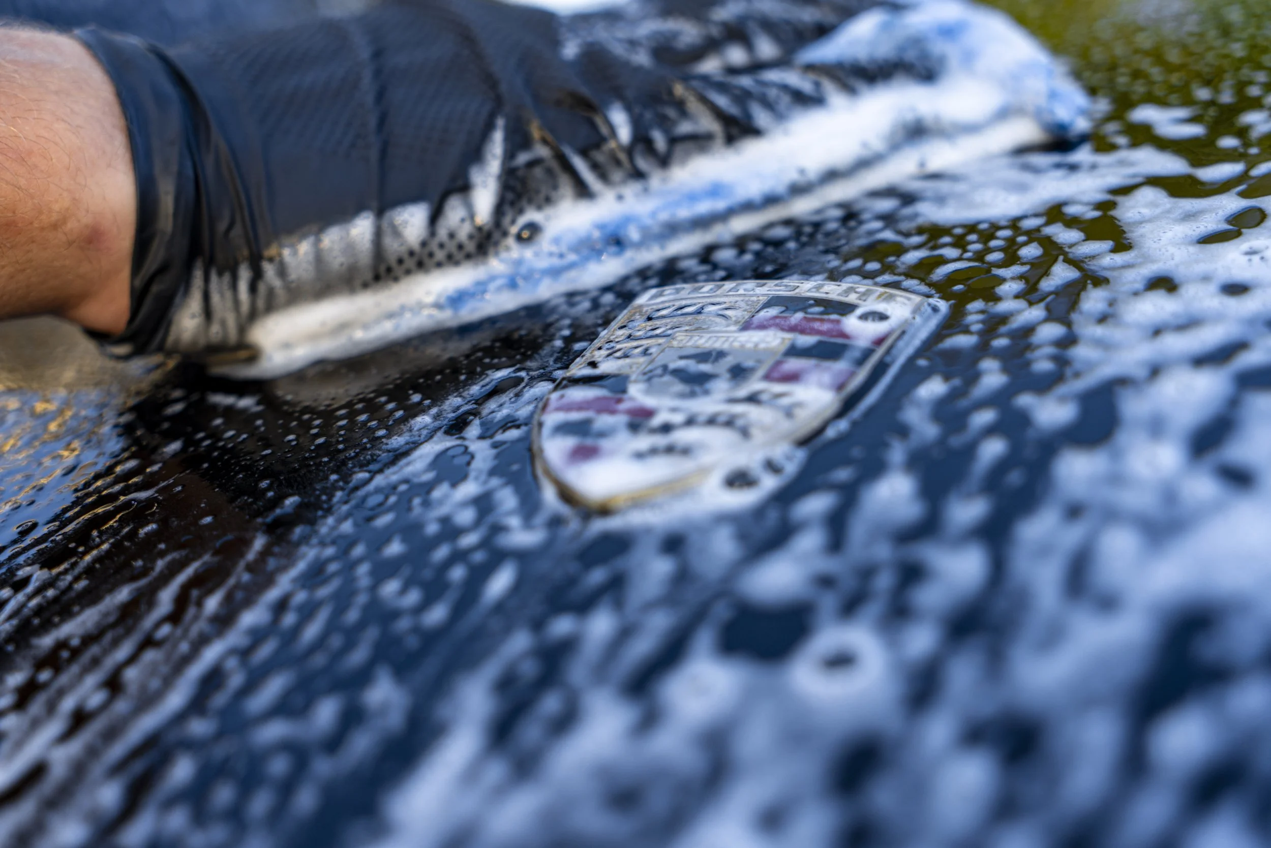 Police badge detail service — emergency vehicle cleaning by Reflections Perfection with foam and polish.