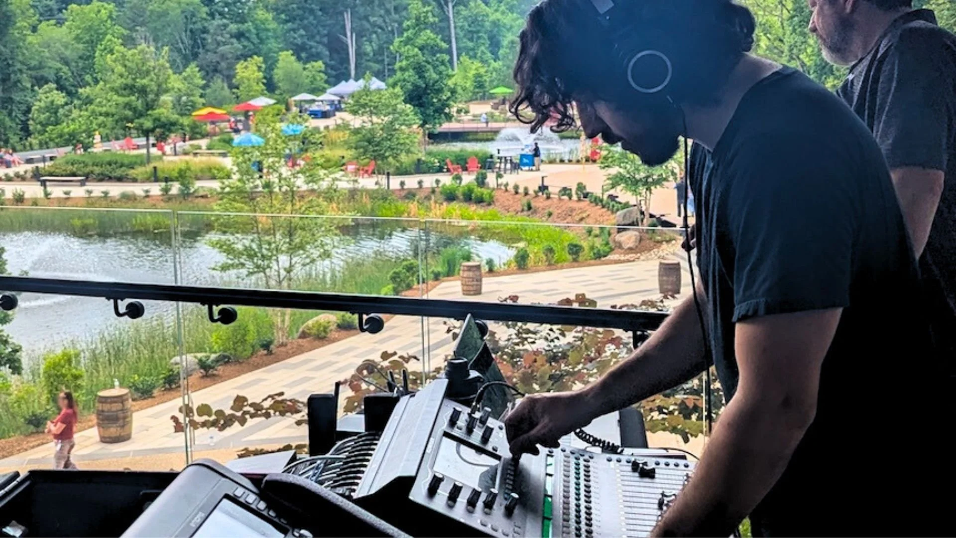 Audio engineer at a corporate event. He is adjusting levels for the band and optimizing the sound for the space.